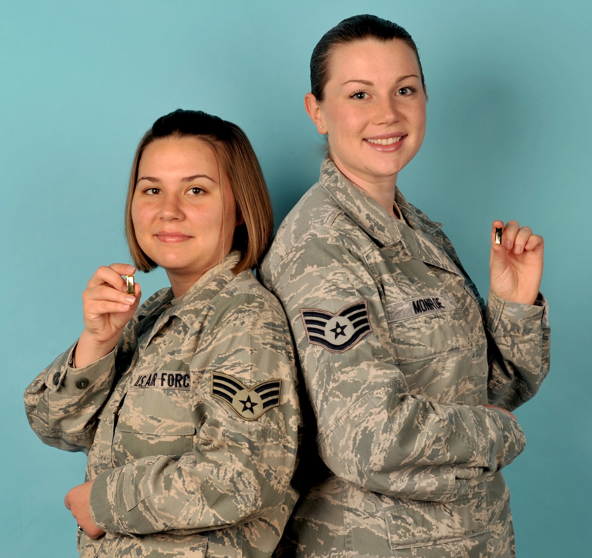 Senior Airman Megan France and Staff Sgt. Annabel Monroe, 2nd Operations Support Squadron, display their projected rank on Barksdale Air Force Base, La., March 22. Both submitted commissioning packages in Nov. 2011 after eight months of preparation. Recently, France was notified of her acceptance into the Scholarship for Outstanding Airmen to ROTC program and Monroe was notified of her acceptance into the Airman Scholarship and Commissioning Program. (U.S. Air Force photo/Senior Airman Amber Ashcraft) (RELEASED)