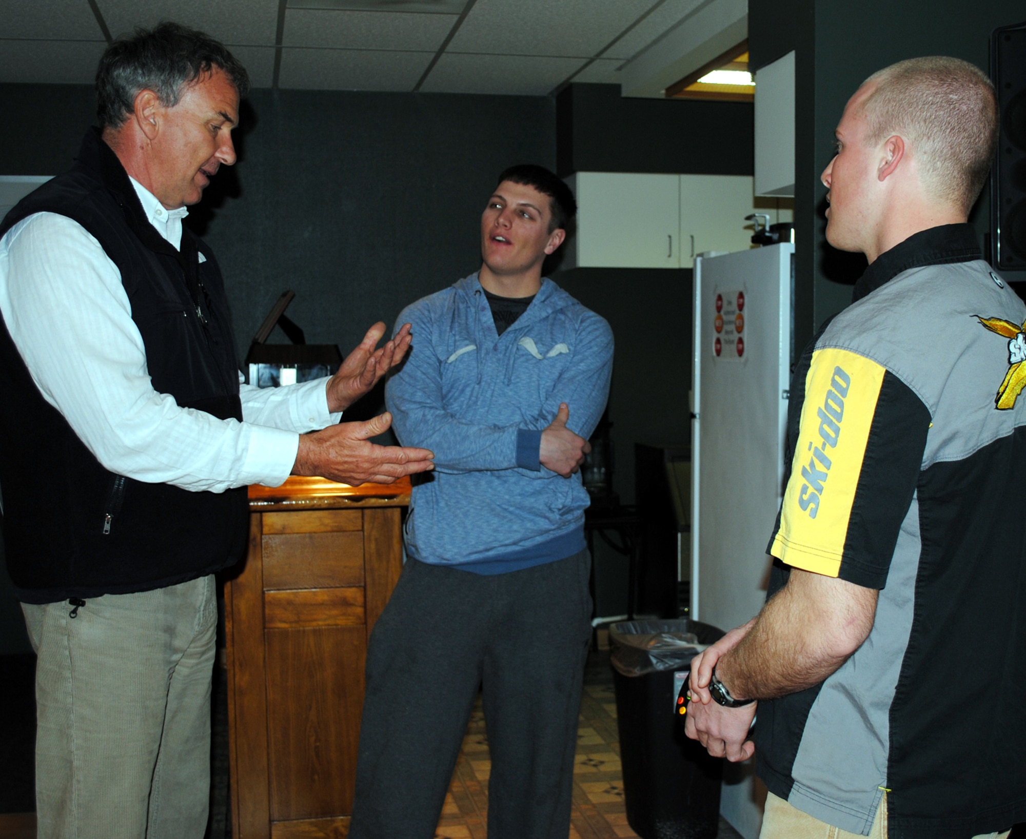 Tom Whittaker, motivational speaker and the first disabled person to reach the summit of Mount Everest, discusses life as an avid mountaineer to Airmen 1st Class Dean Beckley, 819th RED HORSE Squadron heavy equipment operator (left), and Tracy Wetzel, 819th RHS pavement and equipment operator, at the Airman’s Center March 21. (U.S. Air Force photo/Airman 1st Class Katrina Heikkinen)