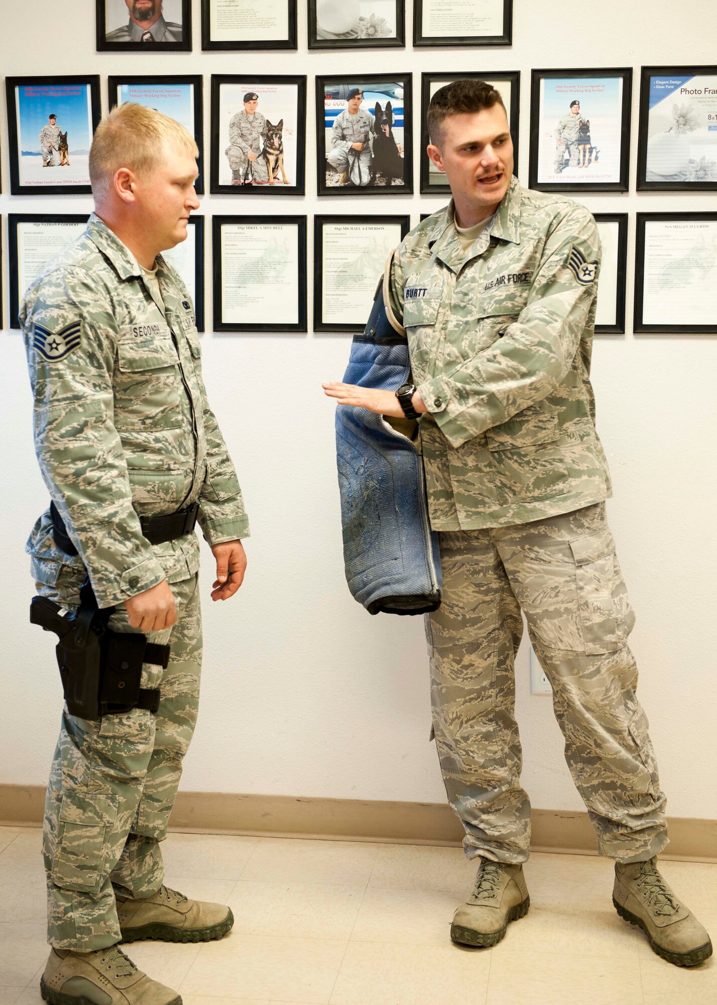 HOLLOMAN AIR FORCE BASE, N.M. -- Staff sergeants Christopher Secondi and Zachary Burtt, 49th Security Forces Squadron military working dog handlers, demonstrate proper safety and decoy techniques during a decoy training class March 20. Burtt and Secondi go over basic procedures before taking the students outside to participate as decoys with the MWD. K-9s are used throughout the military to detect explosive devices and illegal narcotics and assist during patrol on military installations worldwide. (U.S. Air Force photo by Airman Leah Ferrante/Released)