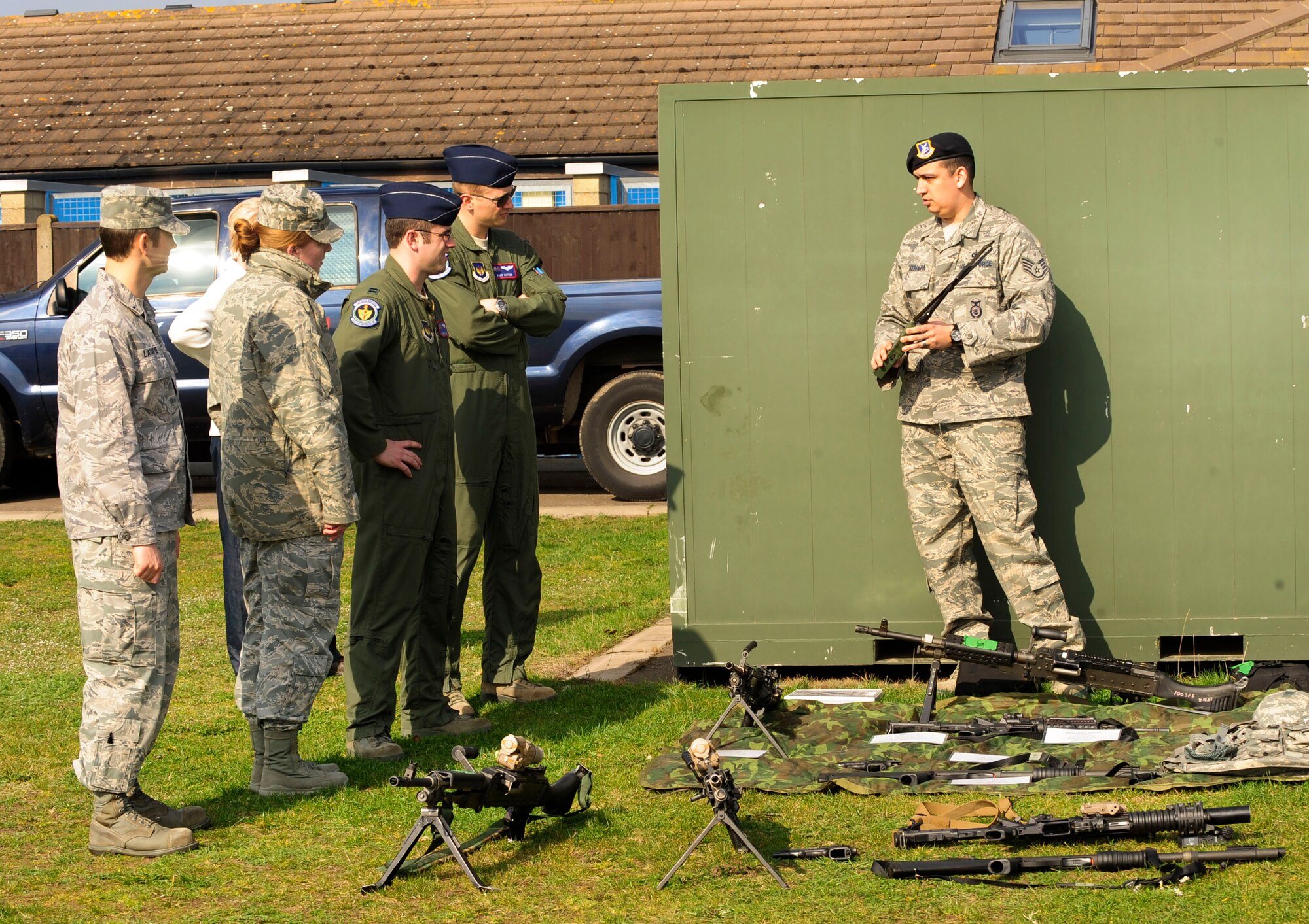 RAF MILDENHALL, England – Staff Sgt. James Herrera, (right) 100th Security Forces Squadron armory NCO in charge, briefs a group of company grade officers on the small arms weapons that security have available use here March 21, 2012. The CGOs were briefed on several aspects of 100th SFS operations as part of an immersion program run by the Company Grade Officer Council to help CGOs better understand how each squadron supports the mission. (U.S. Air Force photo/Senior Airman Ethan Morgan)