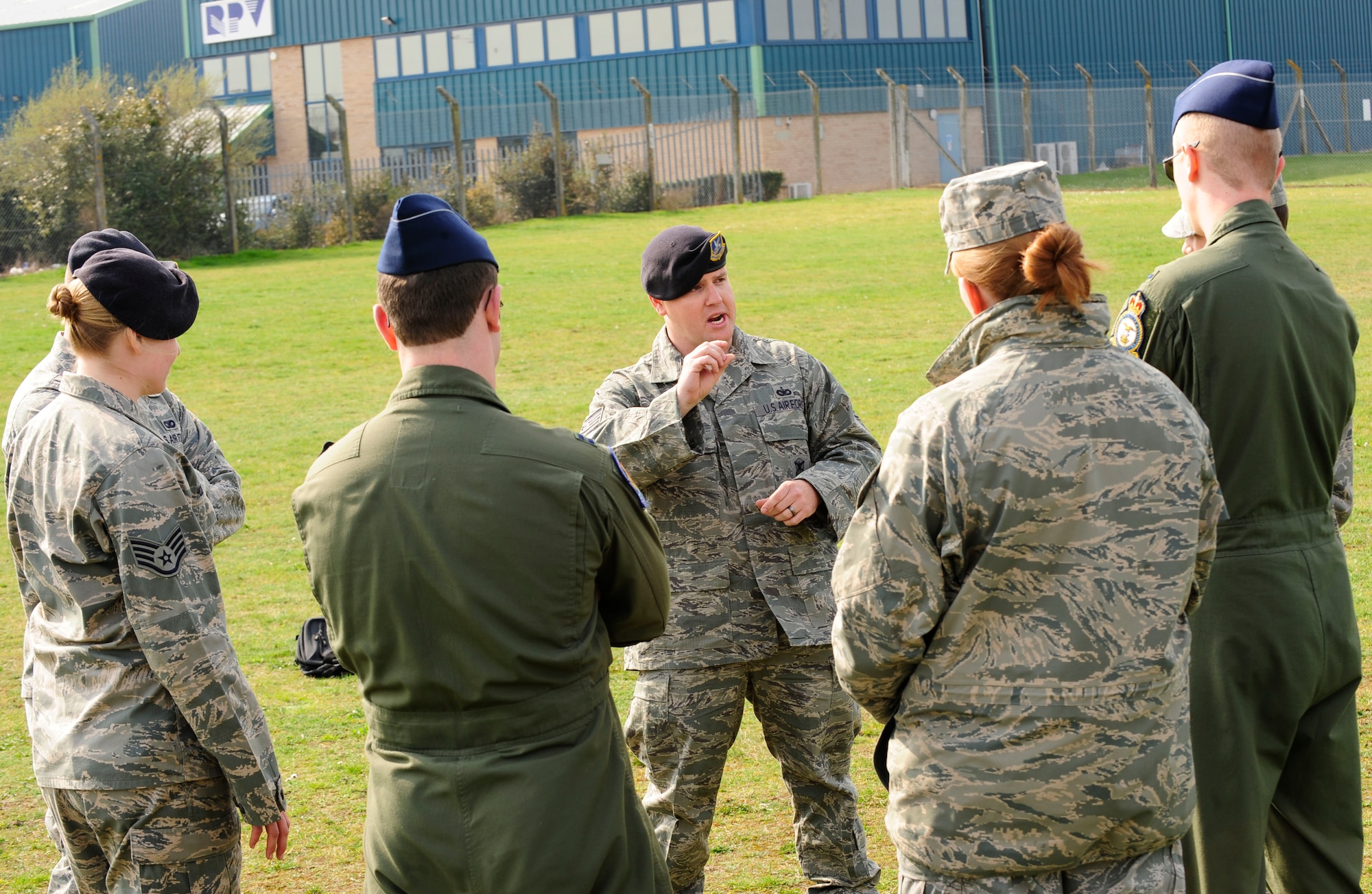 RAF MILDENHALL, England – Staff Sgt. Kaylon Pendleton, (center) 100th Security Forces Squadron military working dog handler, briefs a group of company grade officers on the substance detection capabilities of the 100th SFS military working dogs here March 21, 2012. The briefing was part of an immersion program run by the Company Grade Officer Council to help CGOs better understand how each squadron supports the mission. (U.S. Air Force photo/Senior Airman Ethan Morgan)
