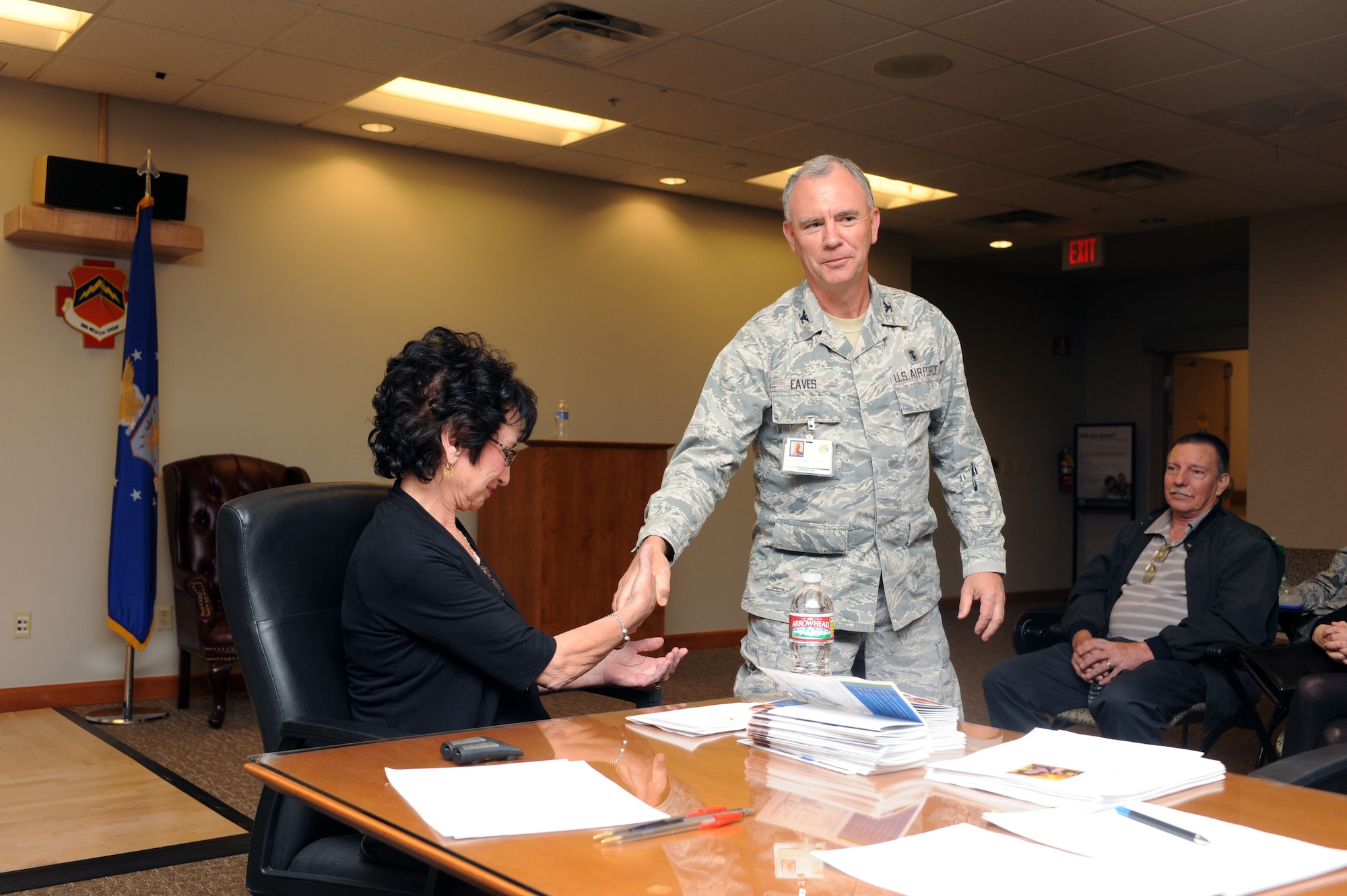 Col. Richard Eaves, 56th Medical Group, presented a coin to DiDi Tart, guest speaker for the Colon Awareness Month event March 7 at Luke Air Force Base.  Tart is a colon cancer survivor of more than 25 years.  She travels the United States sharing her story of recovery and living well.  (U.S. Air Force photo by Airman 1st Class Devante Williams)