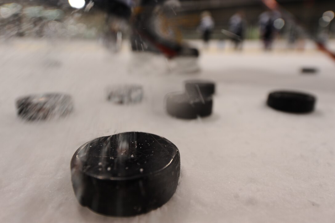 A puck hit by an Ellsworth Bombers hockey player slices down the ice at the Roosevelt Ice Park Arena in Rapid City, S.D., March 19, 2012. Airmen interested in joining the team and improving their hockey skills can contact the team manager, Maj. Shawn Bock, 37th Bomb Squadron assistant director of operations, at (605) 385-5783. (U.S. Air Force photo by Airman 1st Class Zachary Hada/Released)
