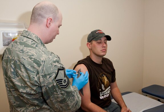 Master Sgt. Steven Burns, 28th Medical Operations Squadron NCO in charge of immunizations, administers an influenza vaccination to Staff Sgt. Carl Amarr, 28th Maintenance Squadron aerospace craftsman, at Ellsworth Air Force Base, S.D., March 13, 2012. An annual influenza vaccine is the first and most important step in protecting against flu viruses. (U.S. Air Force photo by Airman 1st Class Zachary Hada/Released)