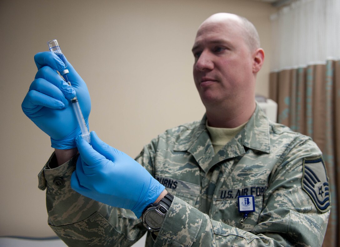 Master Sgt. Steven Burns, 28th Medical Operations Squadron NCO in charge of immunizations, prepares an influenza vaccine for an Airman at Ellsworth Air Force Base, S.D., March 13, 2012. The vaccination is mandatory for all military members and can be received at the 28th MDOS immunizations clinic Monday through Friday, from 7:30 a.m. to 4 p.m. (U.S. Air Force photo by Airman 1st Class Zachary Hada/Released) 