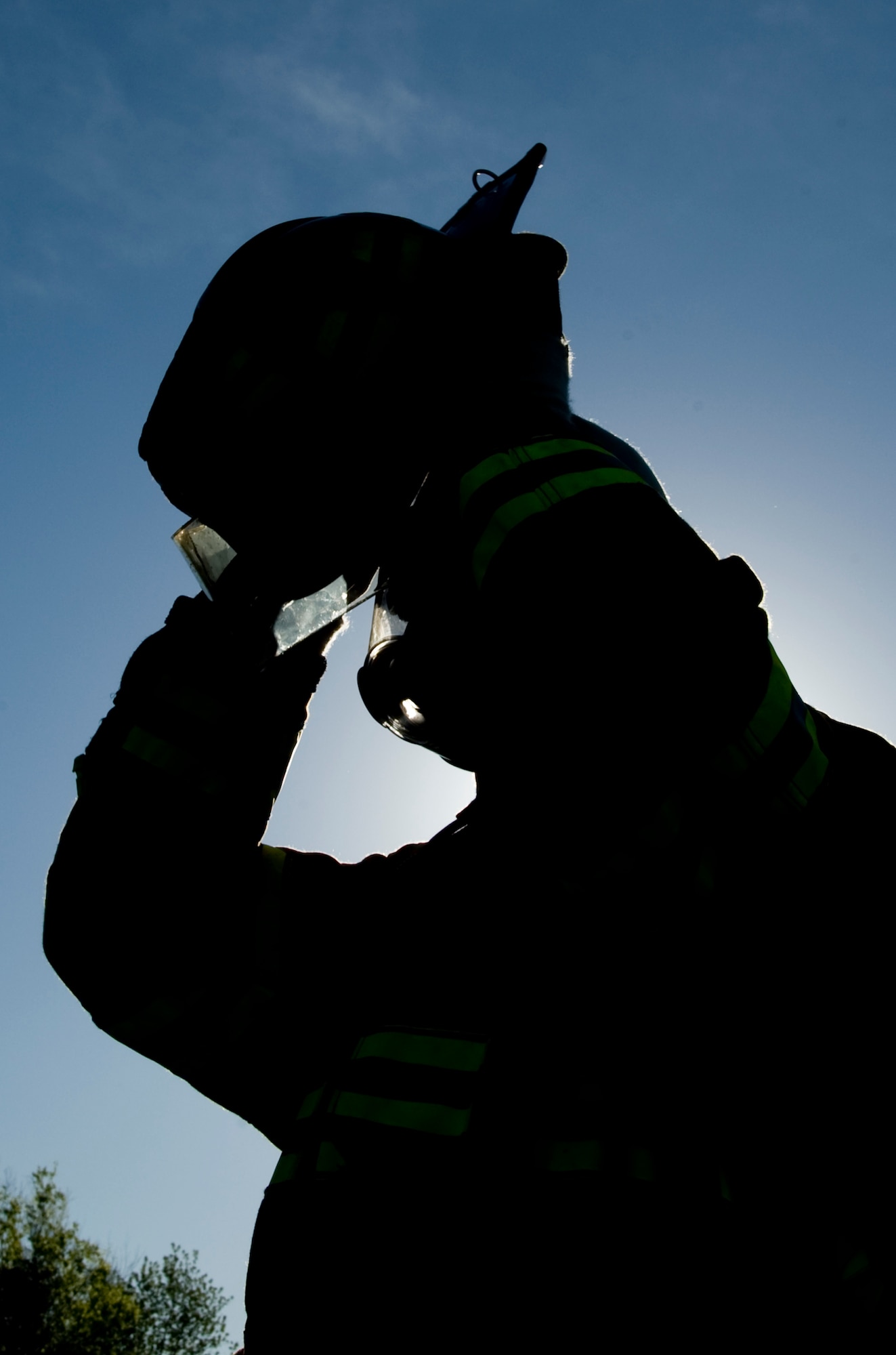 A firefighter from the Shreveport Fire Department puts his helmet on before participating in a live burn exercise on Barksdale Air Force Base, La., March 22. Every year, firefighters from the SFD train on a mock B-52H Stratofortress to be recertified on aircraft fires. (U.S. Air Force photo/Airman 1st Class Benjamin Gonsier)(RELEASED)