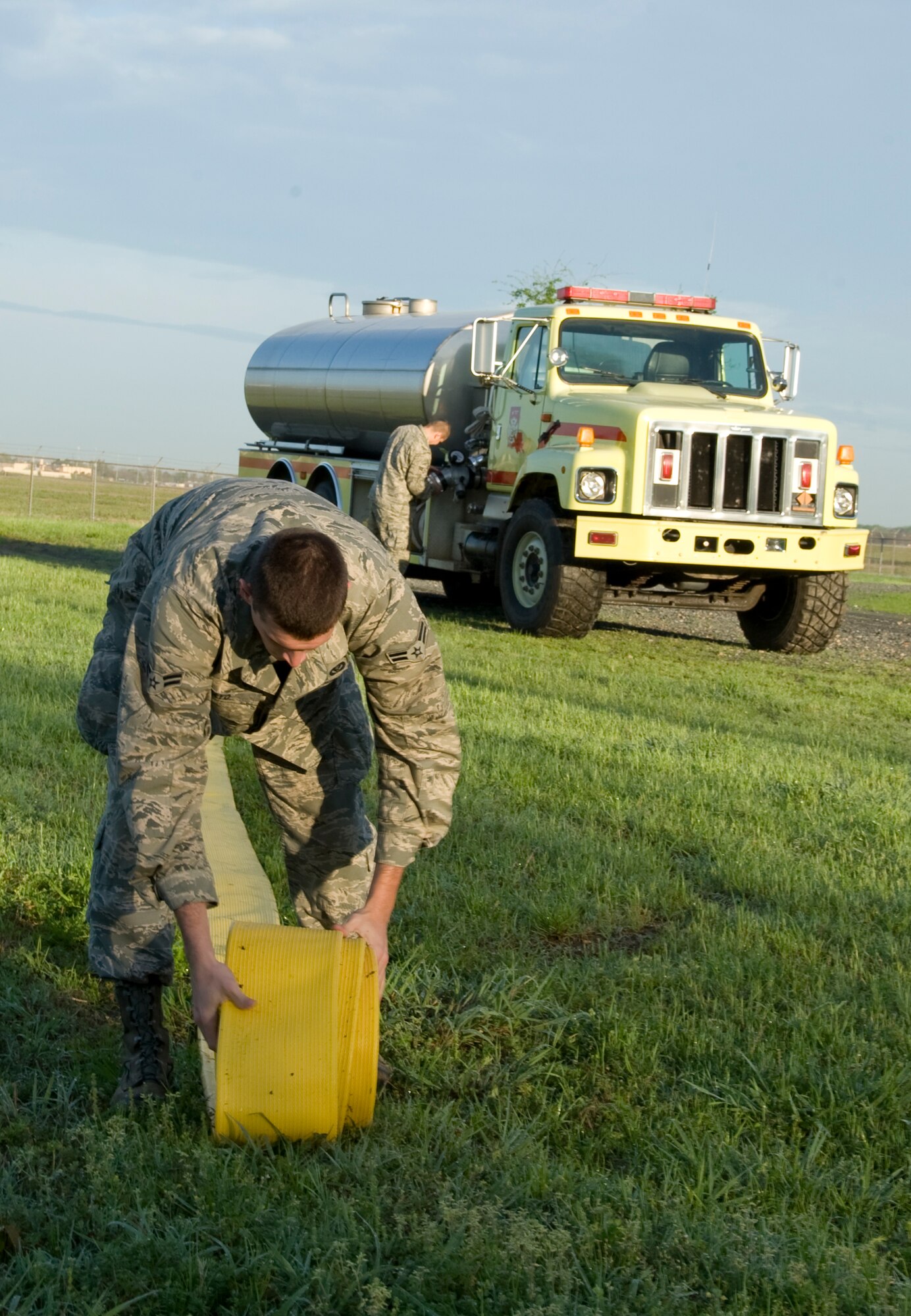 Airman 1st Class Cory Mayo, 2nd Civil Engineer Squadron Fire Department, rolls out a hose from Tanker 11 on Barksdale Air Force Base, La., March 22. The tanker is able to hold up to 5,000 gallons of water. (U.S. Air Force photo/Airman 1st Class Benjamin Gonsier)(RELEASED)

