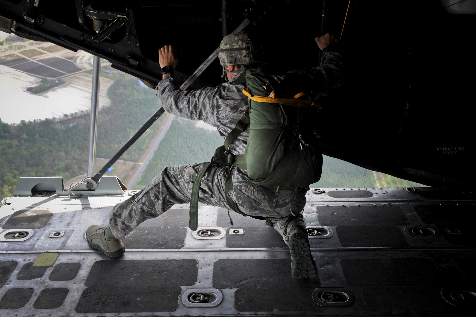 U.S. Air Force Staff Sgt. Tyler Smitka, 823d Base Defense Squadron fire team leader, looks for the drop zone before jumping out of an HC-130P Combat King at Moody Air Force Base, Ga., March 21, 2012. After Smitka spotted the DZ, he readied all jumpers for the drop. (U.S. Air Force photo by Airman 1st Class Douglas Ellis/Released)
