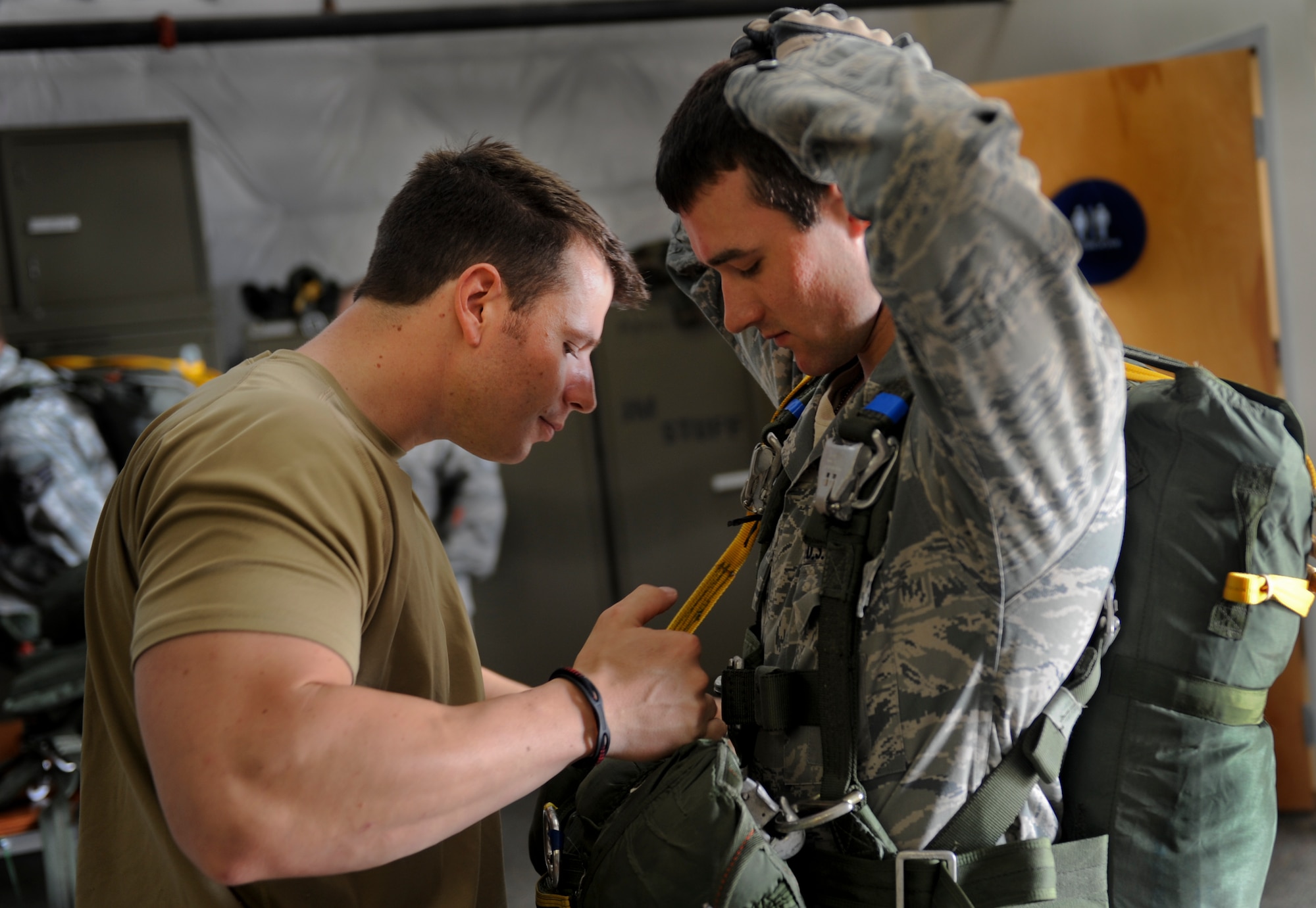 U.S. Air Force Staff Sgt. Tyler Smitka, 823d Base Defense Squadron fire team leader, performs a buddy check at Moody Air Force Base, Ga., March 21, 2012. One of the duties of a jumpmaster is to ensure all jumpers and their gear are ready for the jump.  (U.S. Air Force photo by Airman 1st Class Douglas Ellis/Released)
