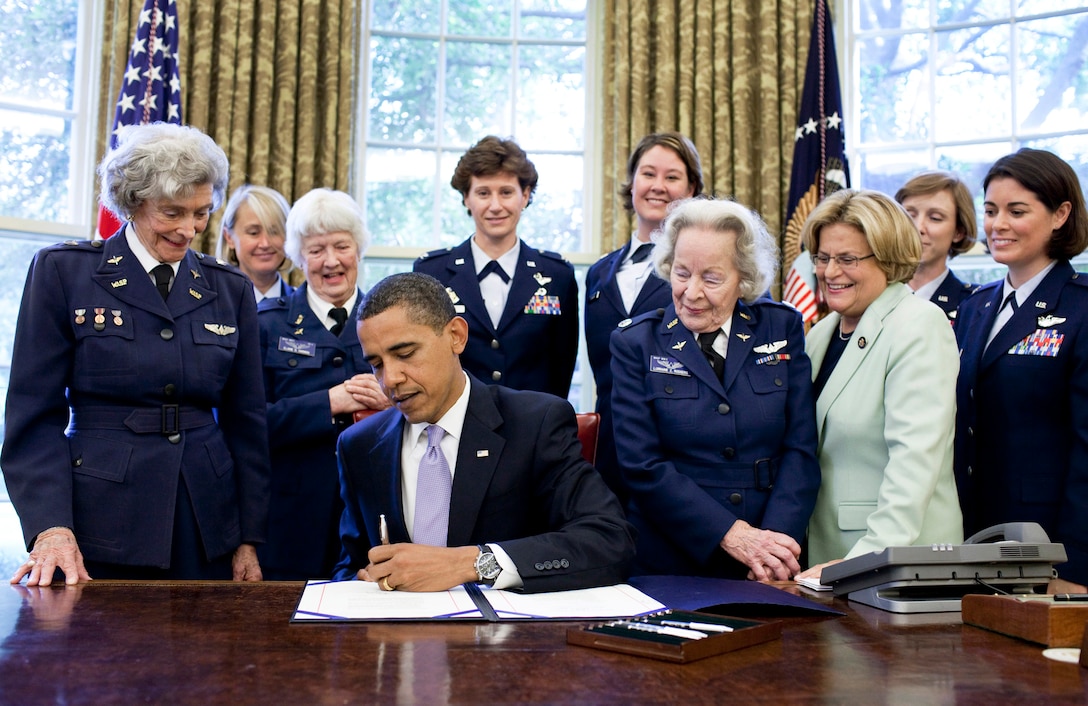 President Barack Obama signs S.614 in the Oval Office at the White House in 2009. The bill awarded a Congressional Gold Medal to Women Airforce Service Pilots. (Air Force photo/Pete Souza)