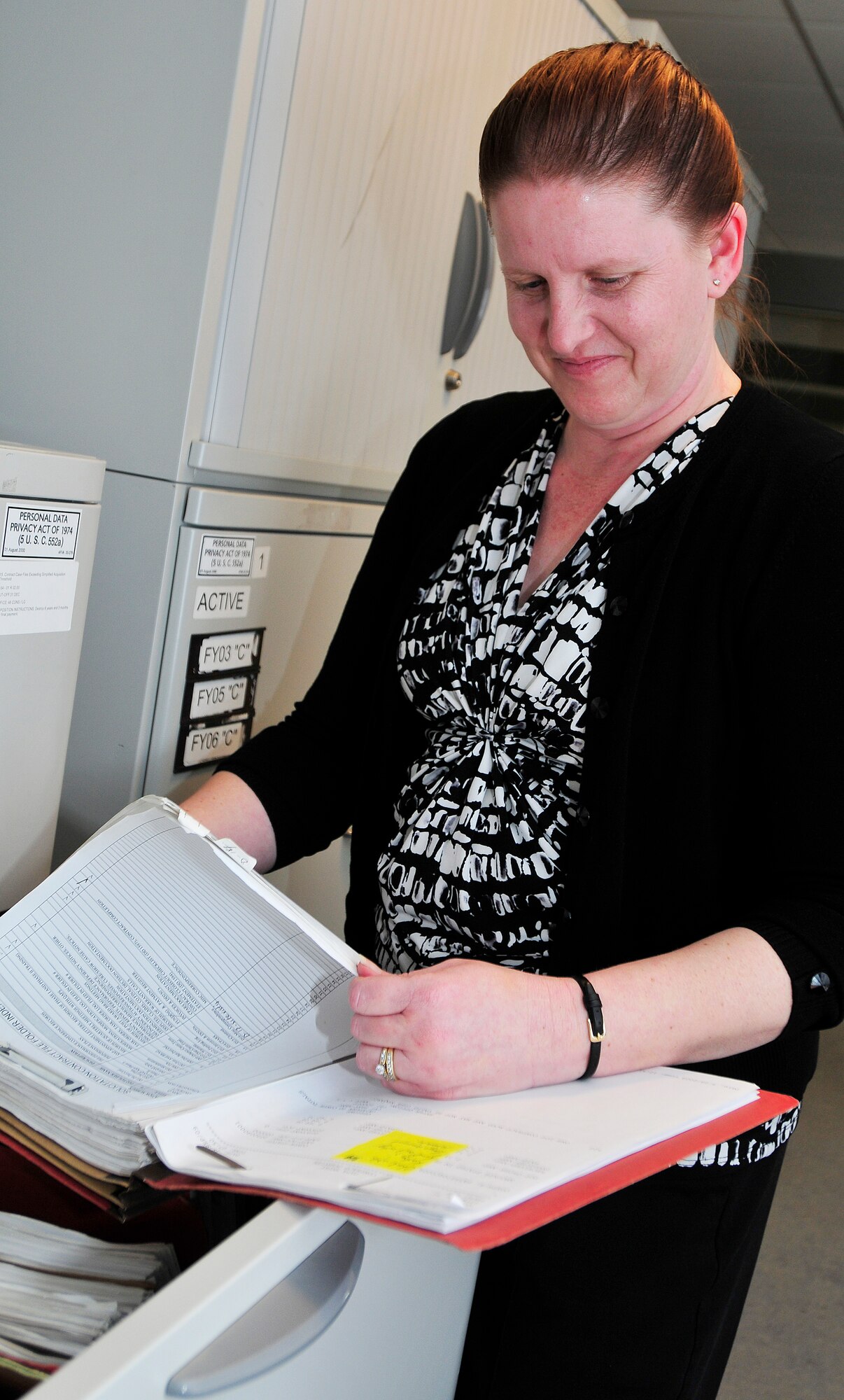 ROYAL AIR FORCE LAKENHEATH, England - Shannon Brown, 48th Contracting Squadron contract specialist, sorts through files March 21, 2012. Brown was nominated for a Liberty Spotlight because she displays the core value of "Excellence in All We Do." (U.S. Air Force photo by Senior Airman Tiffany M. Deuel)