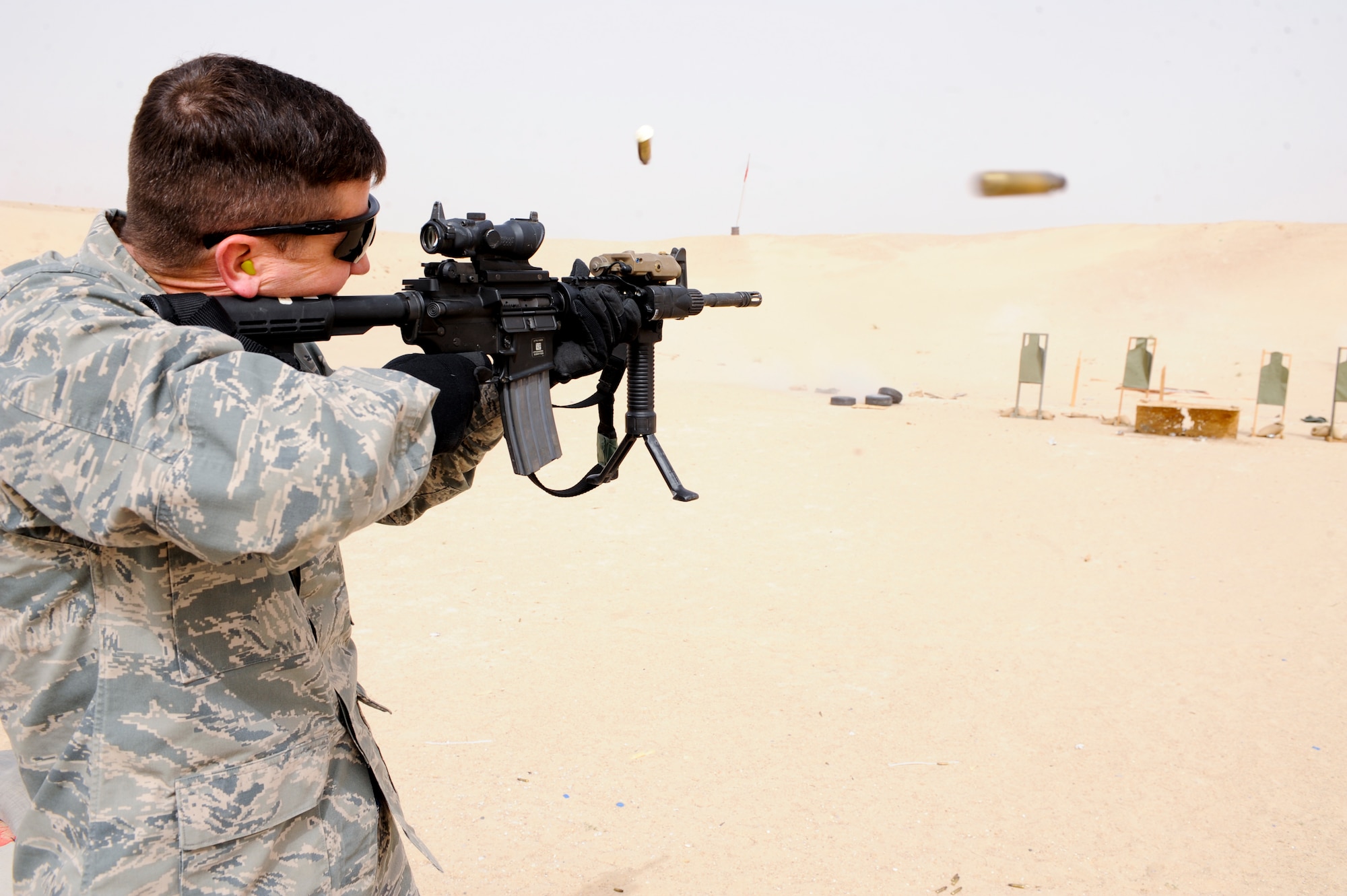 SOUTHWEST ASIA  -- Lt. Col. Paul K. Carlton III, 332nd Air Expeditionary Wing director of staff, fires the M4 assault rifle at an undisclosed location in Southwest Asia, March 23, 2012. Wing Staff Agency members received weapons familiarization training on multiple weapons that the 332nd Expeditionary Security Forces Squadron uses on a daily basis. Carlton is deployed from Hill Air Force Base, Utah, and is a native of San Antonio, Texas. (U.S. Air Force photo by Staff Sgt. Joshua J. Garcia)