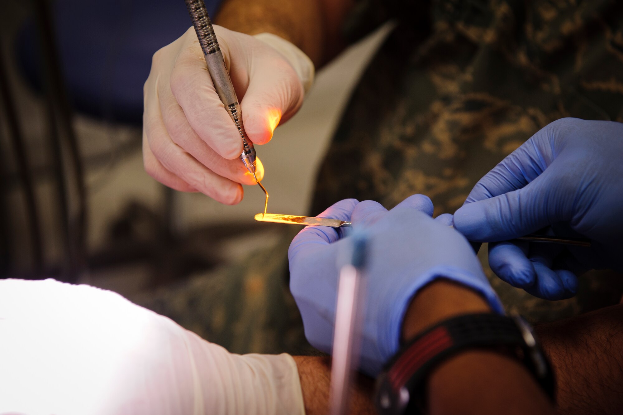 SOUTHWEST ASIA – U.S. Air Force Lt. Col. Richard Eckert, 379th Expeditionary Medical Group dentist, prepares to fill Roy’s tooth here March 15, 2012. (U.S. Air Force photo/Staff Sgt. Nathanael Callon)