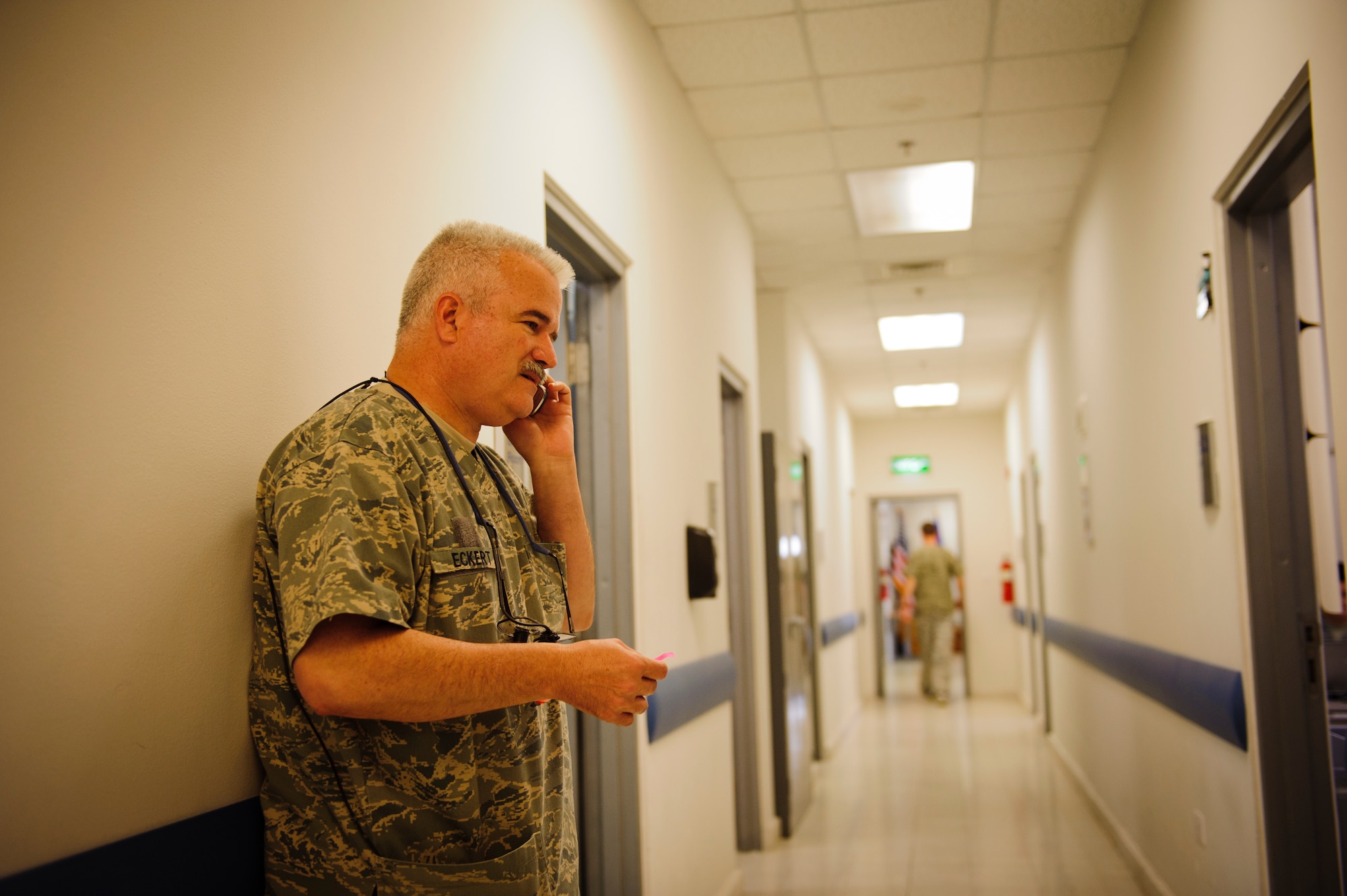 SOUTHWEST ASIA – U.S. Air Force Lt. Col. Richard Eckert, 379th Expeditionary Medical Group dentist, calls an anesthesiologist on standby for assistance in treating Roy, an eight-year-old Belgian Malinois military working dog, here March 15, 2012. (U.S. Air Force photo/Staff Sgt. Nathanael Callon) 