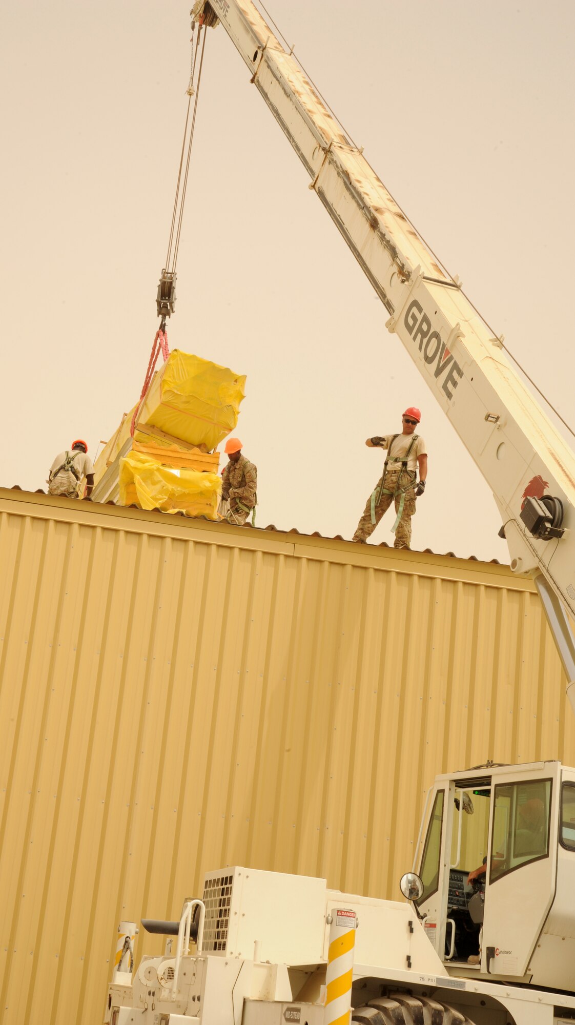 SOUTHWEST ASIA - Airmen construct three, 20,000 square-foot warehouses so the 380th Air Expeditionary Wing can store items sensitive to the harsh weather elements of the area March 22, 2012.  Roughly 30 Rapid Engineer Deployable Heavy Operations Repair Squadron Engineers are deployed to assist the 380th AEW as the base mission evolves to an enduring operation. RED HORSE units can go anywhere in the world and build whatever's needed there, all while being as self-sufficient as possible. (U.S. Air Force photo/Tech. Sgt. Arian Nead)
