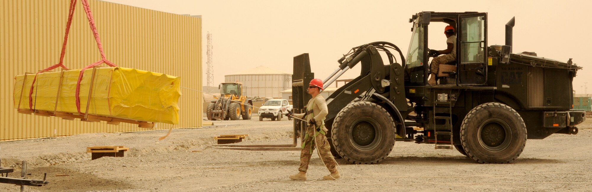 SOUTHWEST ASIA - Airmen construct three, 20,000 square-foot warehouses so the 380th Air Expeditionary Wing can store items sensitive to the harsh weather elements of the area March 22, 2012.  Roughly 30 Rapid Engineer Deployable Heavy Operations Repair Squadron Engineers are deployed to assist the 380th AEW as the base mission evolves to an enduring operation. RED HORSE units can go anywhere in the world and build whatever's needed there, all while being as self-sufficient as possible. (U.S. Air Force photo/Tech. Sgt. Arian Nead)