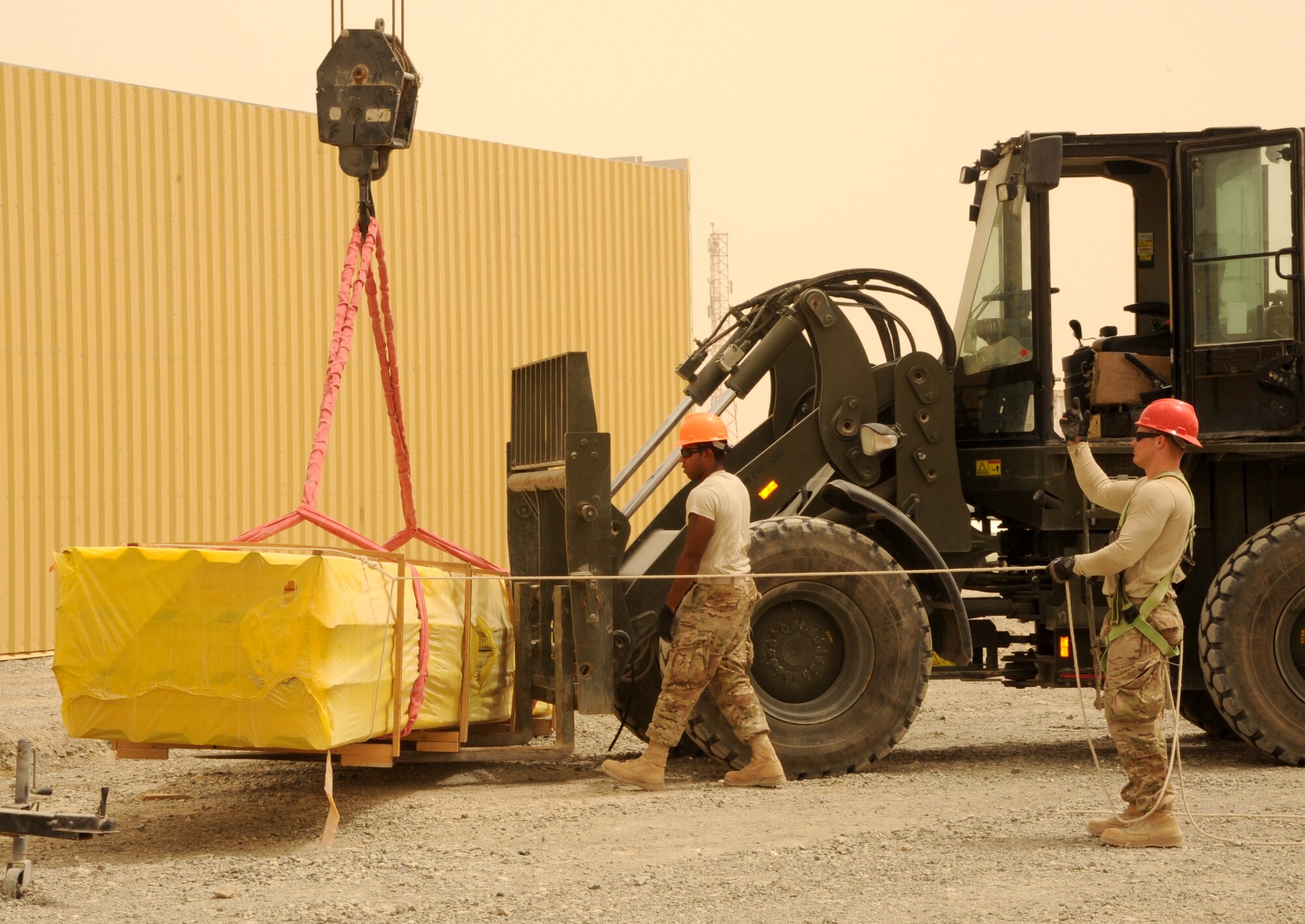 SOUTHWEST ASIA - Airmen construct three, 20,000 square-foot warehouses so the 380th Air Expeditionary Wing can store items sensitive to the harsh weather elements of the area March 22, 2012.  Roughly 30 Rapid Engineer Deployable Heavy Operations Repair Squadron Engineers are deployed to assist the 380th AEW as the base mission evolves to an enduring operation. RED HORSE units can go anywhere in the world and build whatever's needed there, all while being as self-sufficient as possible. (U.S. Air Force photo/Tech. Sgt. Arian Nead)