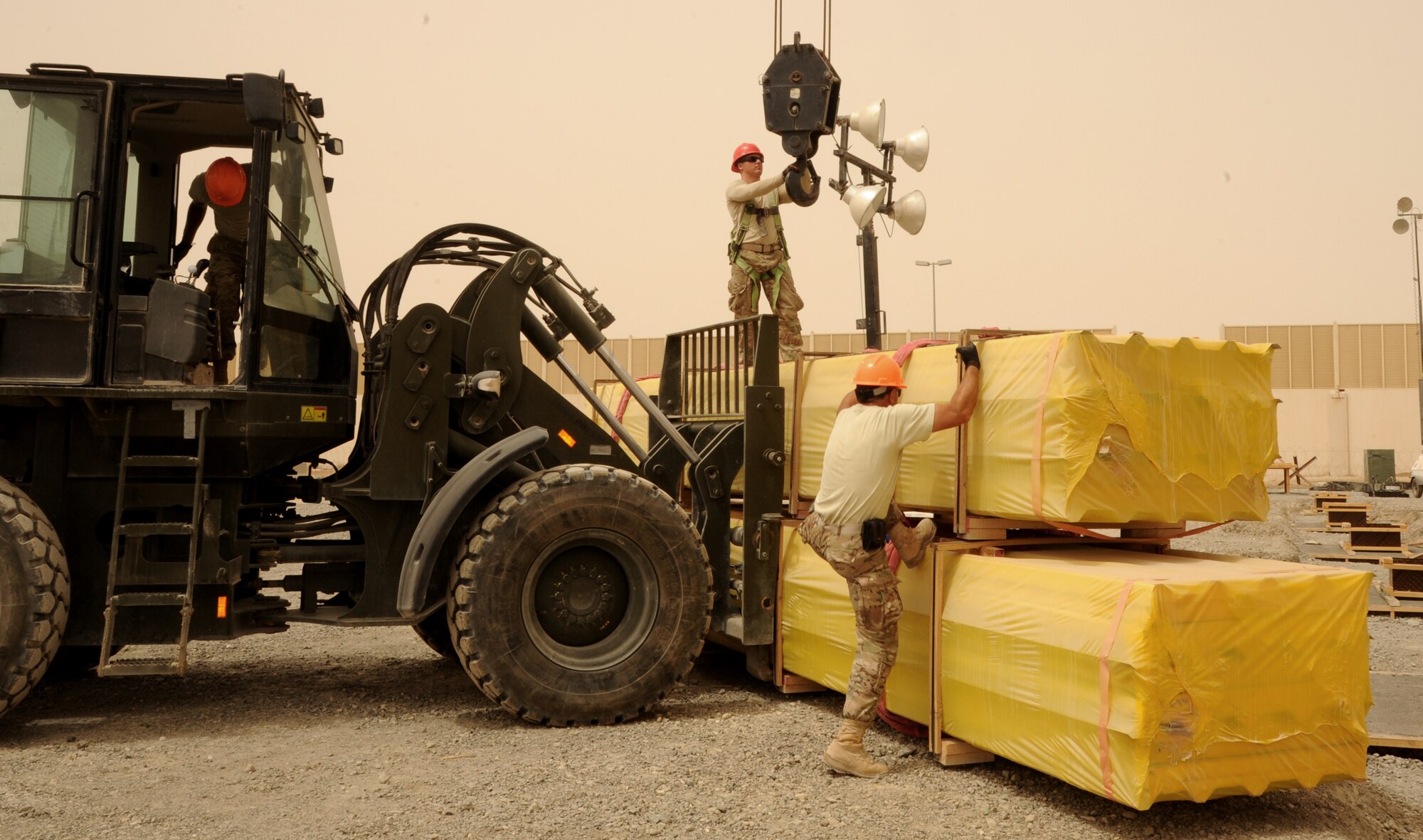 SOUTHWEST ASIA - Airmen construct three, 20,000 square-foot warehouses so the 380th Air Expeditionary Wing can store items sensitive to the harsh weather elements of the area March 22, 2012.  Roughly 30 Rapid Engineer Deployable Heavy Operations Repair Squadron Engineers are deployed to assist the 380th AEW as the base mission evolves to an enduring operation. RED HORSE units can go anywhere in the world and build whatever's needed there, all while being as self-sufficient as possible. (U.S. Air Force photo/Tech. Sgt. Arian Nead)