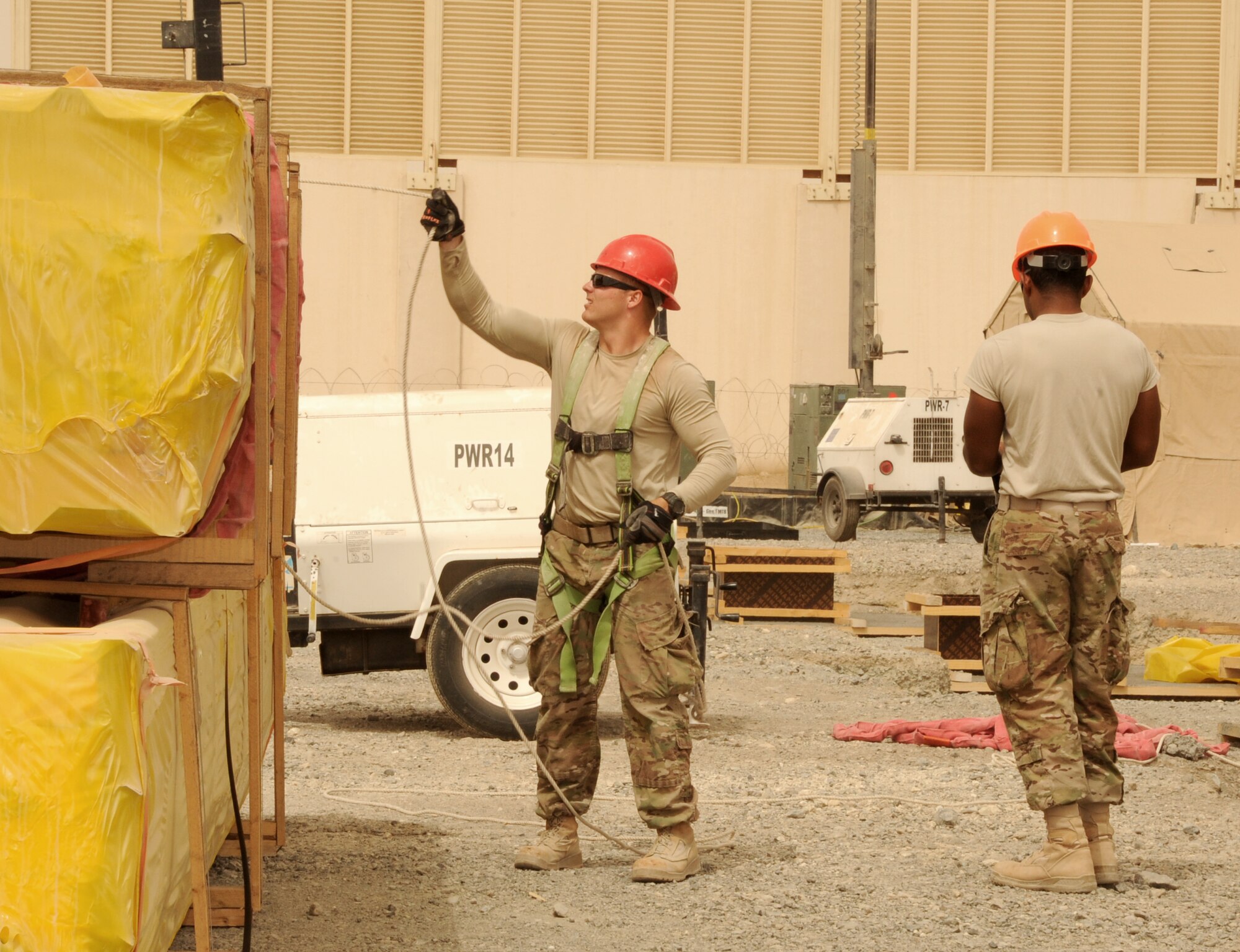 SOUTHWEST ASIA - Senior Airman Justin Brannam secures a stack of insulated roof panels before they are lifted to the top of a construction site March 22, 2012. Roughly 30 Rapid Engineer Deployable Heavy Operations Repair Squadron Engineers are deployed to assist the 380th Air Expeditionary Wing as the base mission evolves to an enduring operation. RED HORSE units can go anywhere in the world and build whatever's needed there, all while being as self-sufficient as possible. Brannam is deployed from Nellis Air Force Base, Nev. (U.S. Air Force photo/Tech. Sgt. Arian Nead)

