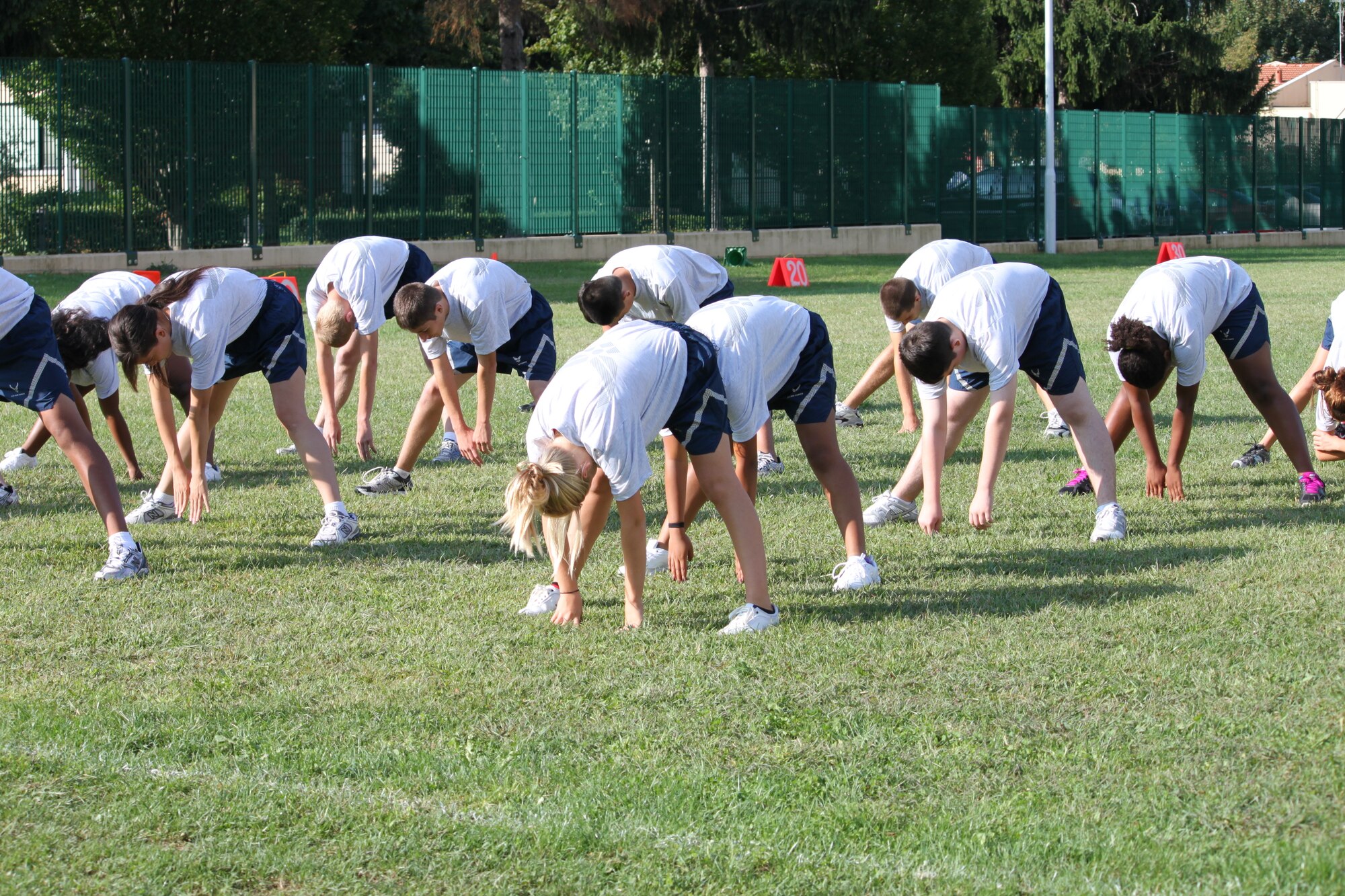 Aviano High School Junior ROTC cadets stretch during physical training March 20 on the high school football field. Cadets are required to attend one workout per week and pass an evaluation once per year.
