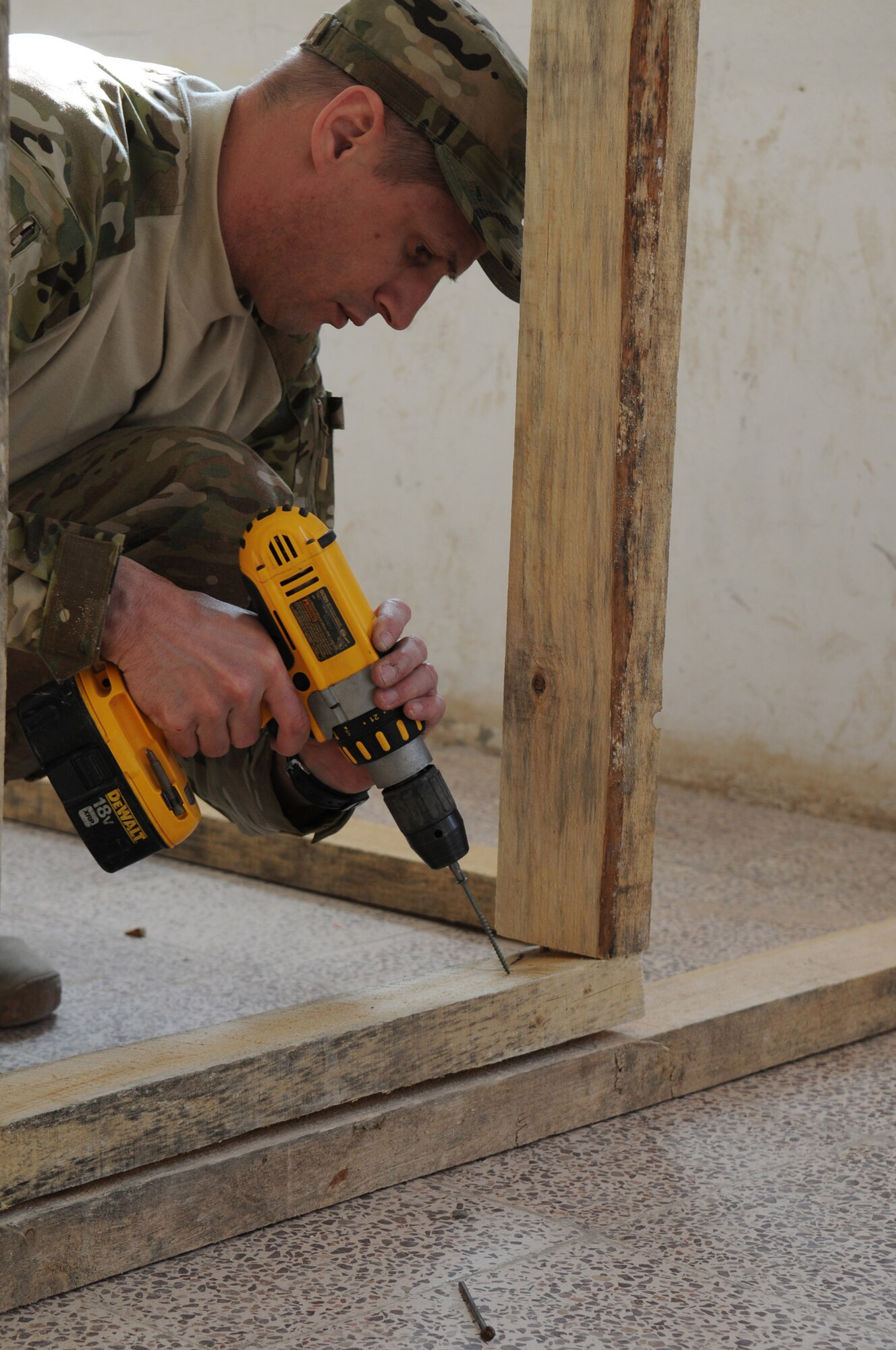 Lt. Col. Daryl Sassaman, 438th Air Expeditionary Wing Thunder Lab officer-in-charge, drills a framing stud into place during the building of a classroom at Shindand Air Base, Afghanistan, March 18, 2012. Sassaman along with other advisers built classrooms, a multipurpose room and an aviation simulator room that will be used as Shindand’s English language training center (SELTC) for the Afghan air force Thunder Lab pilot candidates. (U.S. Air Force photo by Staff Sgt. Nadine Y. Barclay)