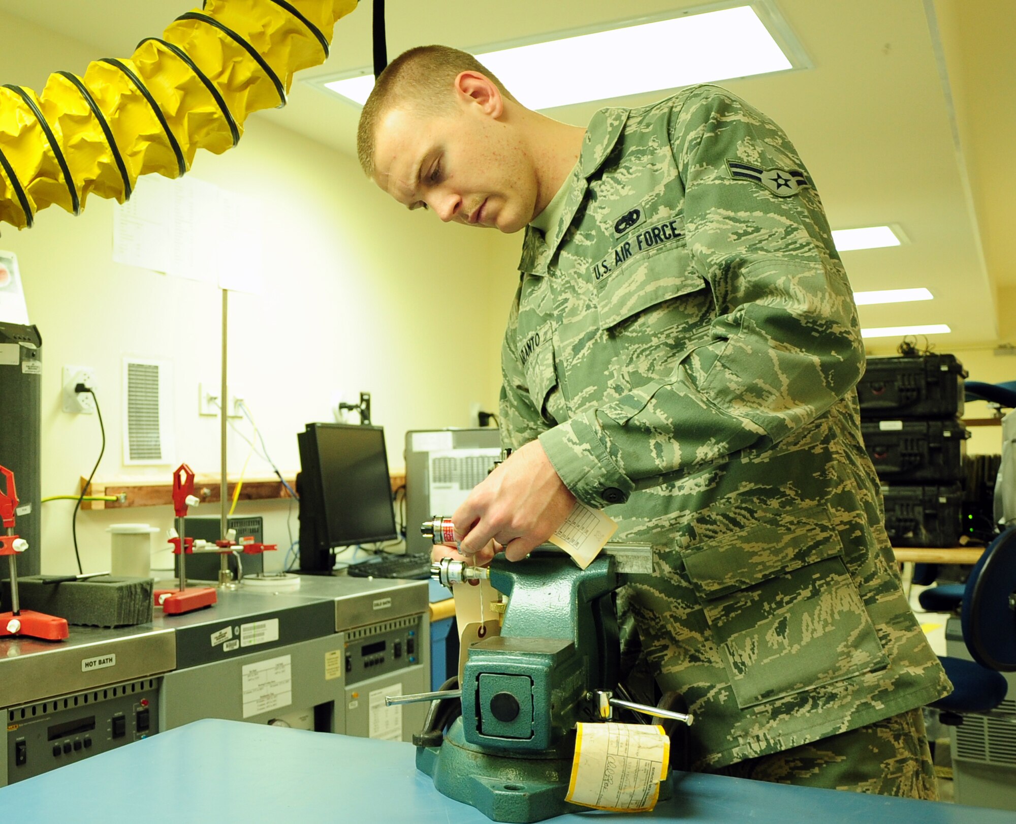 Airman 1st Class David Maranto, a Precision Measurement Equipment Laboratory technician and Princeton, W.V. native, uses a vacuum tube calibrator at the 379th Expeditionary Maintenance Squadron PMEL shop here March 13.  A vacuum tube calibrator to tests steel tubes for leaks and ensure they seal properly. PMEL is responsible for the proper calibration of more than 16,000 items ranging from screws to radar systems. Maranto is currently deployed from Shaw Air Force Base, S.C. (U.S. Air Force photo/ Senior Airman Michael Charles)