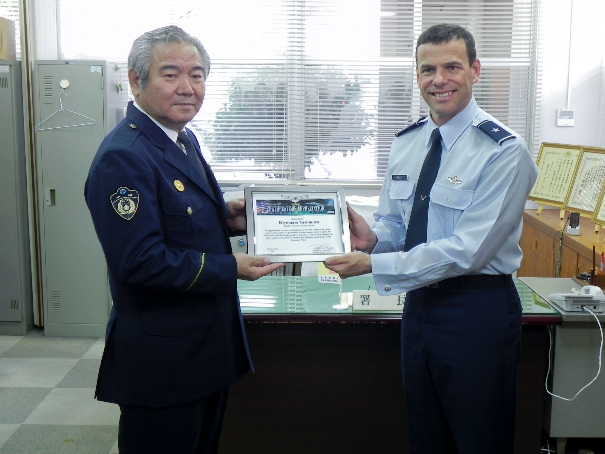 Brig Gen Matt Molloy, 18th Wing commander, presents a certificate of appreciation and a wing coin to Kiyomasa Yasumura, Chief of the Okinawa Police Station during a visit to the station on March 21.  The certificate read, “In appreciation for your outstanding service and cooperation in law enforcement and force protection matters important to Kadena Air Force Base and the lovely people of Okinawa.  Your efforts ensured the safety and security of our communities, bringing great honor to the Japanese Police.”
(U.S. Air Force photo by Maj. Christopher Anderson/Released)
