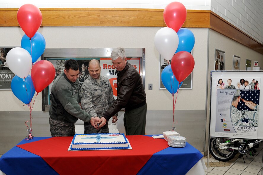 Left to right: U.S. Air Force Capt. Mauricio Kossler, Air Force Assistance Fund assistant project officer, Senior Master Sgt. Quentin Finley, AFAF project officer and Col. Al Wimmer, 35th Fighter Wing vice commander, cut the cake during the AFAF opening ceremony in the Exchange at Misawa Air Base, Japan, March 23, 2012. Airmen can donate to the Air Force Aid Society, the Air Force Enlisted Village, the Air Force Village and the General and Mrs. Curtis LeMay Foundation. (U.S. Air Force photo by Tech. Sgt. Marie Brown/Released)