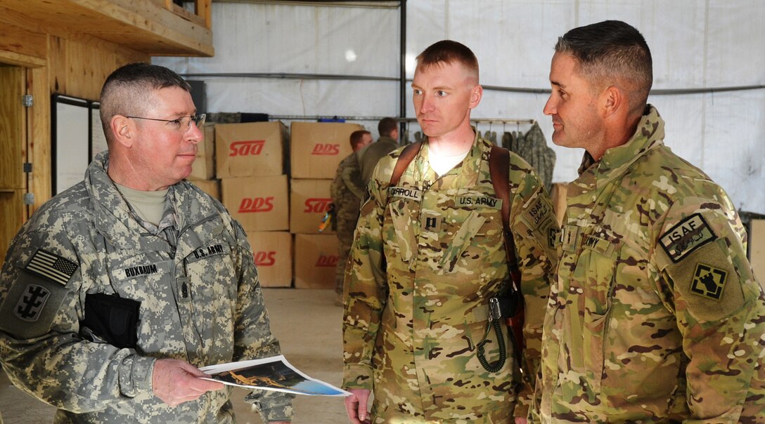 AFGHANISTAN — Command Sgt. Maj. Michael Buxbaum, senior enlisted adviser for U.S. Army Corp of Engineers, visits with Capt. Michael Carroll, commander of Forward Support Company, 7th Engineer Battalion, and Chief Warrant Officer 2 Stanley Hutto during a visit to Forward Operation Base Shank, Afghanistan.