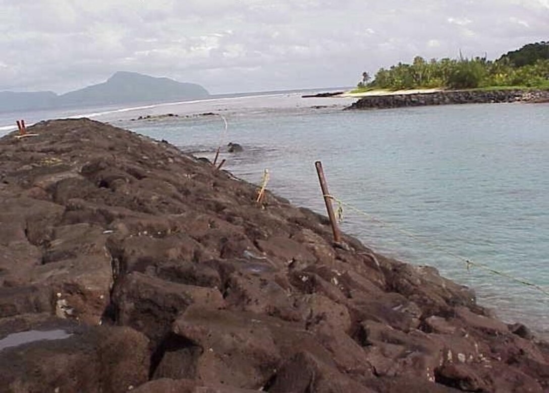 Photo showing portions of the turning basin, revetment, and groin at Tau Small Boat Harbor. 