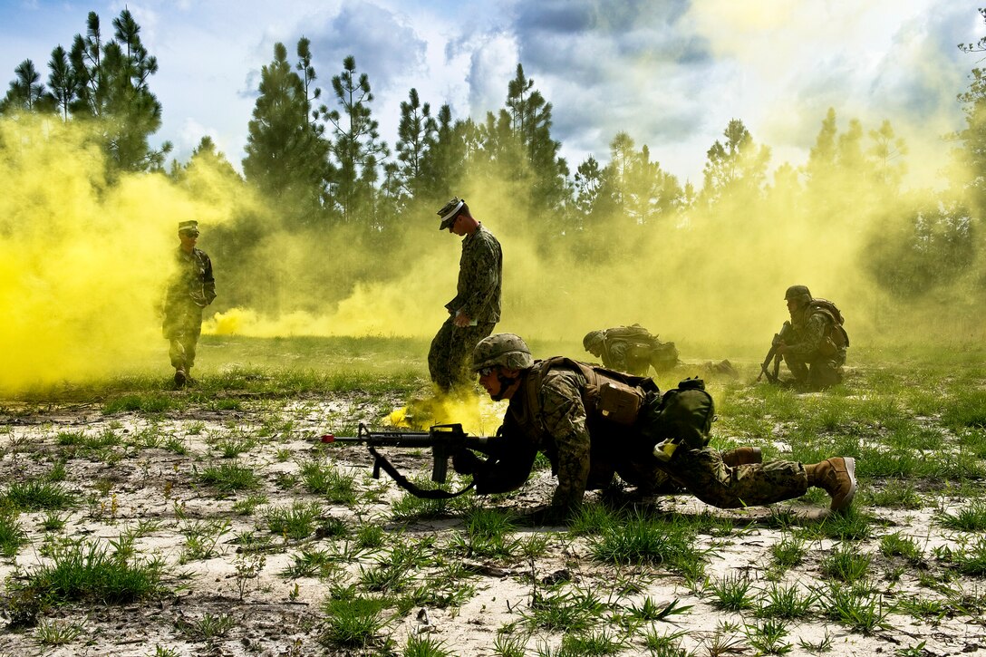 Navy Seabees react to small arms fire during a training exercise on ...