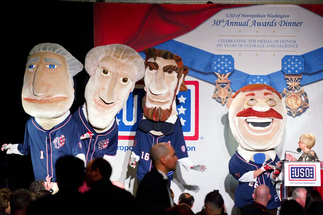 The Washington Nationals' Racing Presidents mascots appear on stage during the USO of Metropolitan Washington 30th Annual Awards Dinner in Arlington, Va., March 22, 2012.