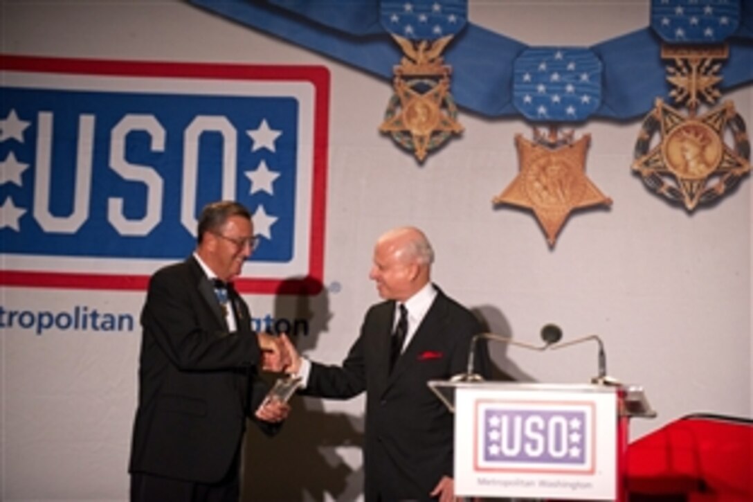 Retired Marine Corps Col. Jay R. Vargas, left, presents the Legacy of Hope Award to Mark Lerner, representing the Washington Nationals, during the USO of Metropolitan Washington 30th Annual Awards Dinner in Arlington, Va. March 22, 2012.