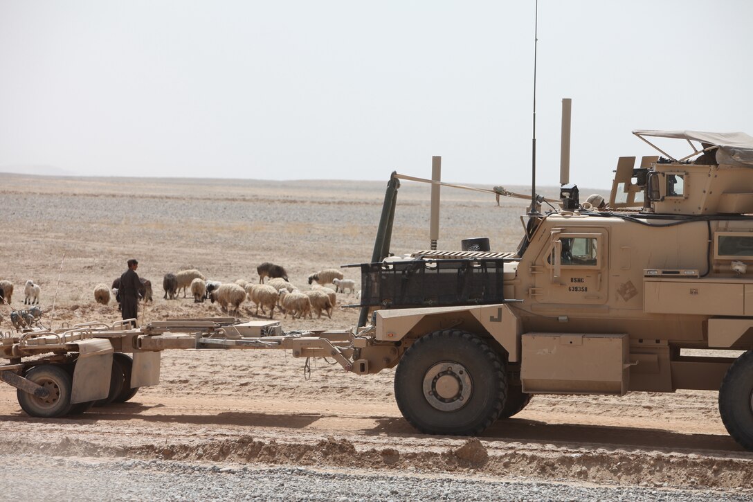 During road construction, Marines with Support Company, 9th Engineer Support Battalion, 1st Marine Logistics Group (Forward) provide security for the construction site outside of Forward Operating Base Geronimo, March 23. "Insurgents use the areas we can't see, like wadis, to move around," said Cpl. Jared Hilton, security team leader, 2nd squad, Security Platoon, Support Co., 9th ESB, 1st MLG (Fwd). "We post security and keep eyes on all avenues of approach, so the heavy equipment operators can work through the day and focus on their task."