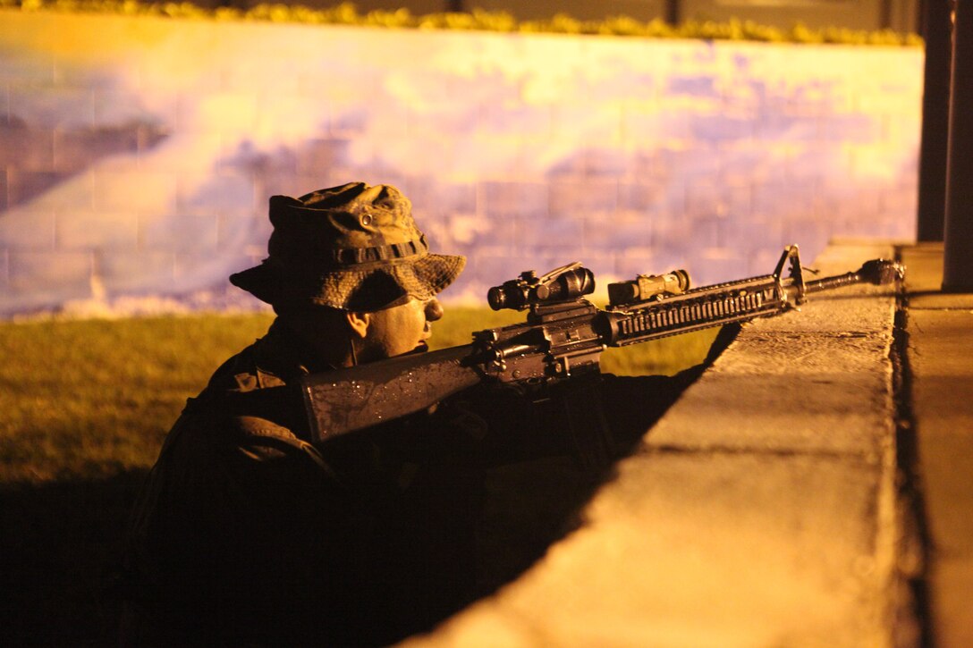 Lance Cpl. Alejandro Carbajal, scout swimmer and rifleman with Company A, Battalion Landing Team 1st Battalion, 4th Marines, 31st Marine Expeditionary Unit, scouts ahead before the primary raid force lands on the shoreline during a small boat raid here, March 17. The raid was conducted during the MEU's Certification Exercise, which upon completion certifies that the MEU is capable to respond to any scenario that may arise. The 31st MEU is the only continuously forward-deployed MEU and is the nation's force in readiness in the Asia-Pacific region.