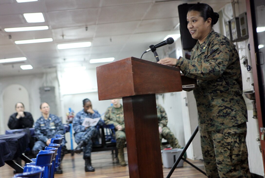 Major Sunny M. Montas, the staff judge advocate of the 31st Marine Expeditionary Unit, and native of Union, N.J., gives a speech as the key note speaker during a ceremony to recognize woman’s history month, March 24. The presentation explained the progressive role women play in the military, as well as how the view of women has changed over the past decades. During the presentation, female Marines and Sailors talked about their experiences, read a poem about life in the military as a woman, and read the biography of Lt. Gen. Carol A. Mutter, the first female to achieve the rank of lieutenant general in the Marine Corps.