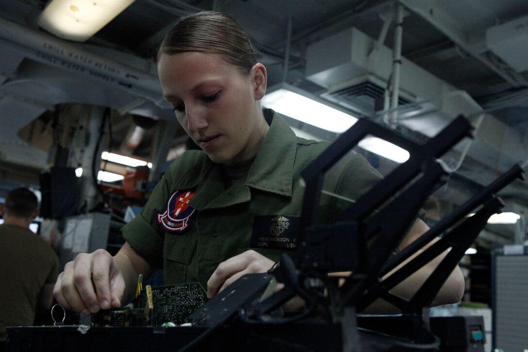 Lance Cpl. Karissa Hendrickson, Marine Fighter Attack Squadron 251 Consolidated Automated Support System technician, takes apart a heads-up display system aboard the aircraft carrier USS Enterprise, March 24. Various shops are present in the avionics branch to provide support for aircraft aboard the carrier.