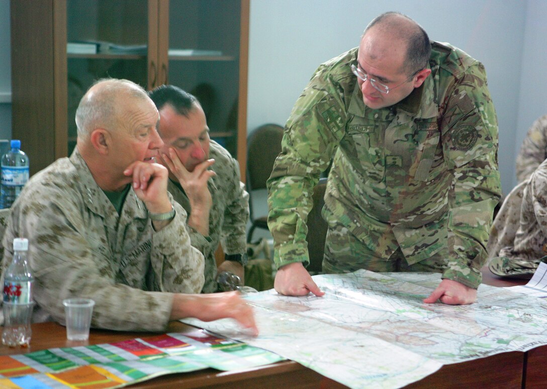 Georgian Lt. Col. Lasha Beridze, Deputy Chief of Joint Staff of the Georgian Armed Forces, shows Lt. Gen. Dennis Hejlik, commanding general of U.S. Marine Forces Europe (MFE) and Brig. Gen. Chuck Chiarotti, deputy commander of MFE, a map of their current location aboard the Kristani Training Area, located just outside Tbilisi, Georgia, March 24. The U.S. and Georgian leaders met to speak with more than 200 Georgian Armed Forces soldiers from the 23rd Light Infantry Battalion about their upcoming mobilization to Afghanistan, as part of MFE's Georgian Deployment Program - International Security Assistance Force (GDP-ISAF).