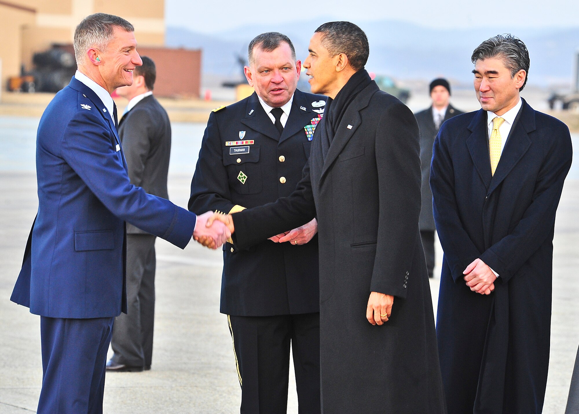 (Left) Col. Patrick McKenzie, 51st Fighter Wing commander, shakes hands with President Barack Obama, March 25, 2012 during introductions by Gen. James Thurman, United States Forces Korea commander . The president transited the base on his way to the 2012 Nuclear Security Summit in Seoul, Republic of Korea. (U.S. Air Force Photo by/ Senior Airman Adam Grant)