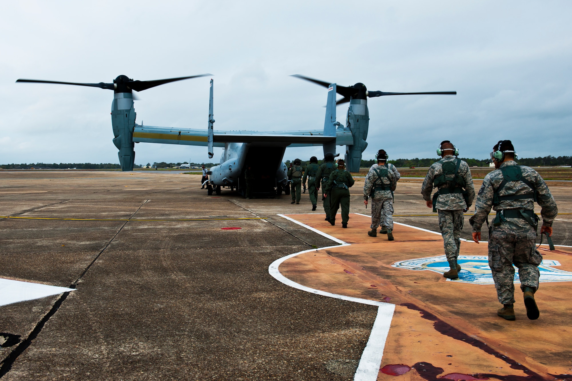 Herschel Walker leads a group of Airmen toward a CV-22 Osprey for an orientation flight over Eglin Air Force Base, Fla., and the Gulf Coast March 22.  Walker visited the base to speak about resiliency and the importance of asking for help. He spoke twice to large crowds of Team Eglin members about his life, career and the emotional and mental struggles he encountered throughout.  (U.S. Air Force photo/Samuel King Jr.)