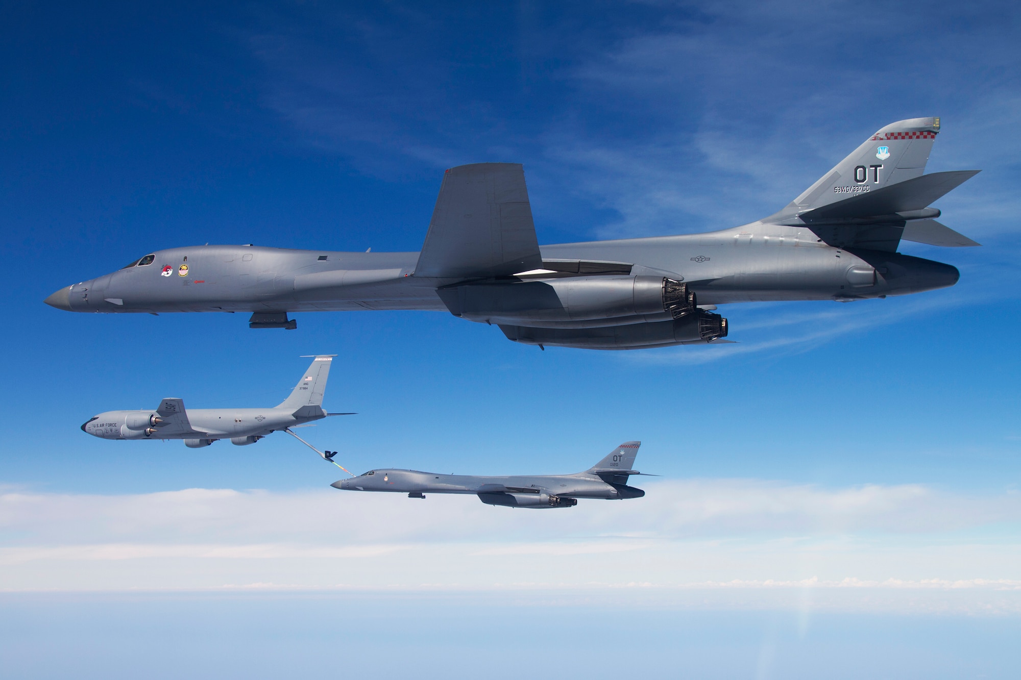 A B-1B Lancer from the 337th Test and Evaluation Squadron stands by as another Lancer connects with the KC-135 Stratotanker for inflight refueling during a mission over the Gulf of Mexico near Eglin Air Force Base, Fla.  The 337th is a geographically separated unit of the 53rd Wing, headquartered at Eglin.  The 337th is responsible for operational testing of all B-1 defensive/offensive systems and weapons upgrades.  (Courtesy photo/Jake Melampy)