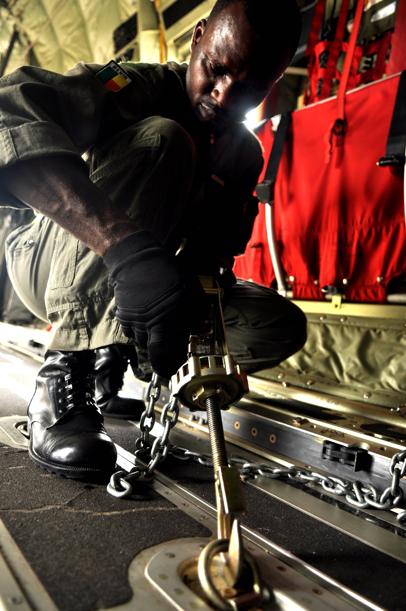 ACCRA, Ghana -- A member of the Benin air force secures a latch onto an U.S. Air Force C-130J Hercules in preparation for the African Partnership Flight capstone event March 12 here. U.S. Air Forces Africa APF 12-2 is a military-to-military partnership building exercise event providing all air forces involved the opportunity to exchange techniques and learn from one another. (U.S. Air Force photo by Senior Airman Natasha Stannard/Released)