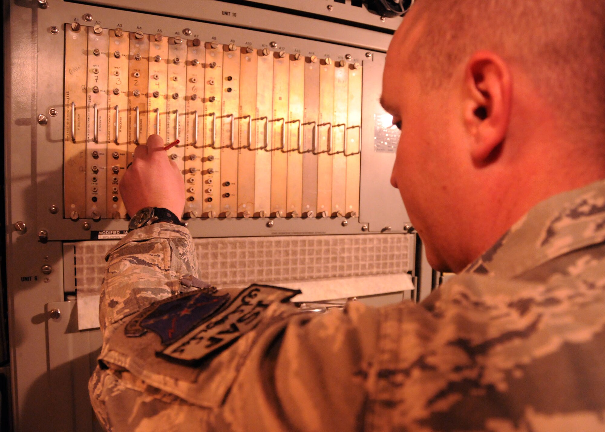 Senior Airman Andrew Dahn, 73rd Expeditionary Air Control Squadron ground radar systems journeyman, is performing a receiver alignment on the radar system here at Kandahar Airfield March 16. Dahn performs radar equipment checks on a daily basis. 