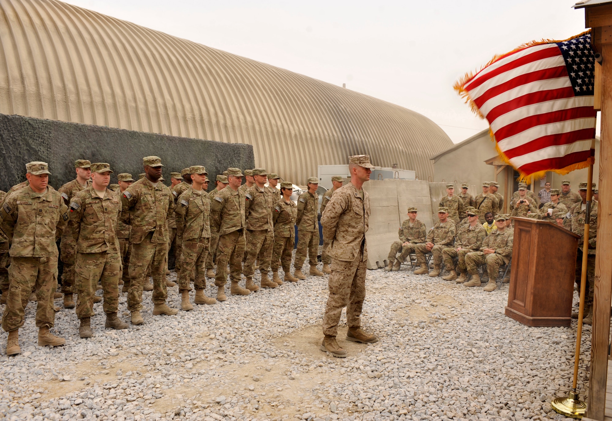 BAGRAM AIRFIELD, Afghanistan— Service members stand at parade rest during a patching ceremony at Bagram Airfield, Afghanistan, March 23, 2012. The members recieved the 11th Theater Tactical Signal Brigade shoulder insignia, a patch that can only be worn in the area of responsibility and is awarded to members  attached to a unit serving in a “declared hostile environment.”  (U.S. Air Force photo/Airman 1st Class Ericka Engblom)