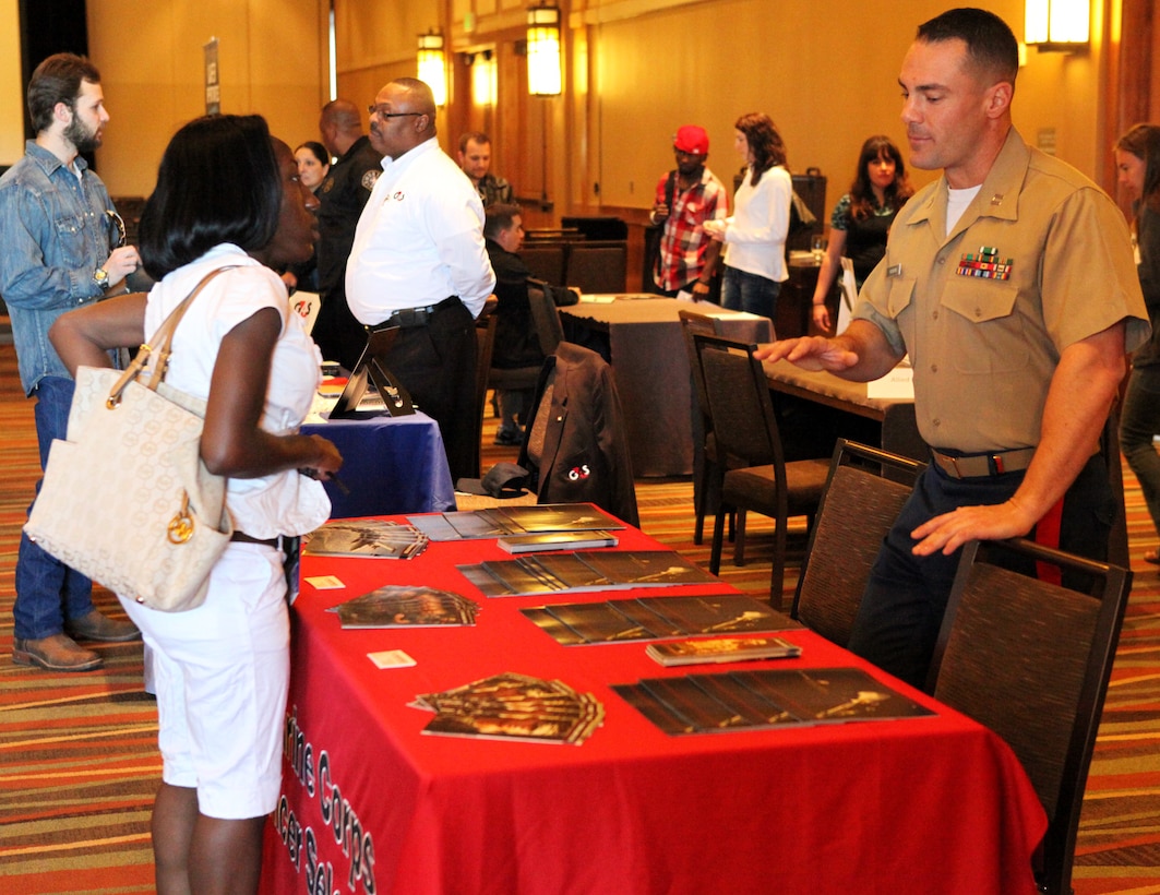 Capt. Esteban Vickers, officer selection officer for Recruiting Station Denver speaks with Cpl. Danelle Whisenhunt, March 24, a Denver resident who has spent one year in the Individual Ready Reserve, regarding reserve officer opportunities available to Marines in the IRR. Whisenhunt was attending the  Mega-Muster for IRR Marines who live within a 150-mile radius of Denver. (U.S. Marine Corps photo by Cpl. Lucas Vega)
