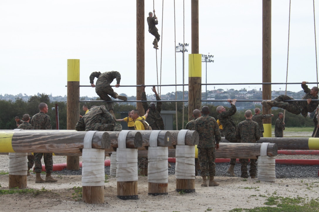 Recruits of Company F, 2nd Recruit Training Battalion went through the 'O-course', an obstacle course that exhausts recruits mentally and physically, aboard Marine Corps Recruit Depot San Diego March 24. The course focuses on upper-body strength and has a series of elevated bars, logs, and walls the allow recruits to try different methods to climb over