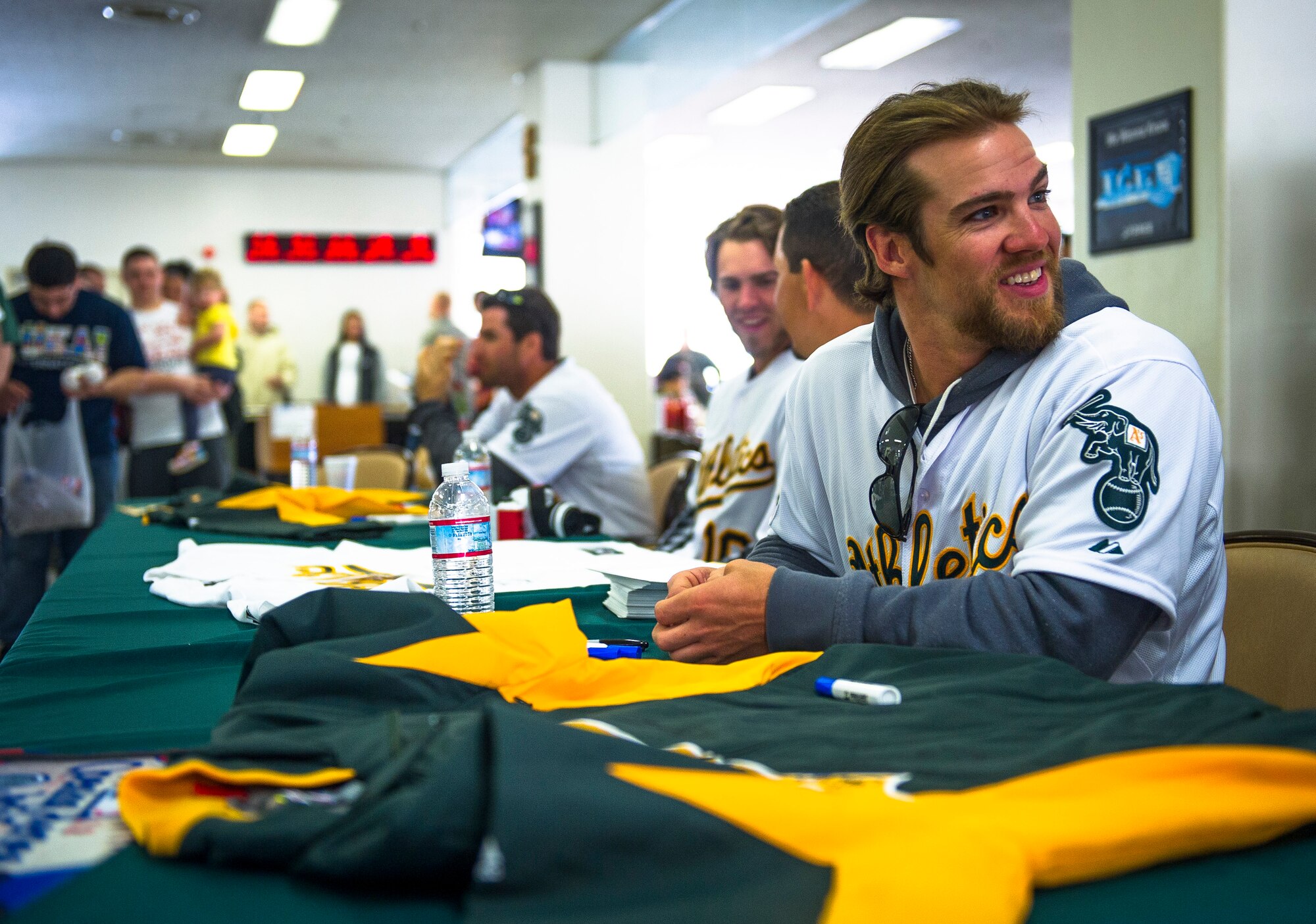 YOKOTA AIR BASE, Japan -- Collin Cowgil, Oakland Athletics right fielder, smiles at a fan waiting to get an autograph here at Yokota Air Base, Japan, March 25, 2012. The players visited the Samurai Cafe to eat with Airmen and sign autographs. (U.S. Air Force photo/Staff Sgt. Chad C. Strohmeyer)