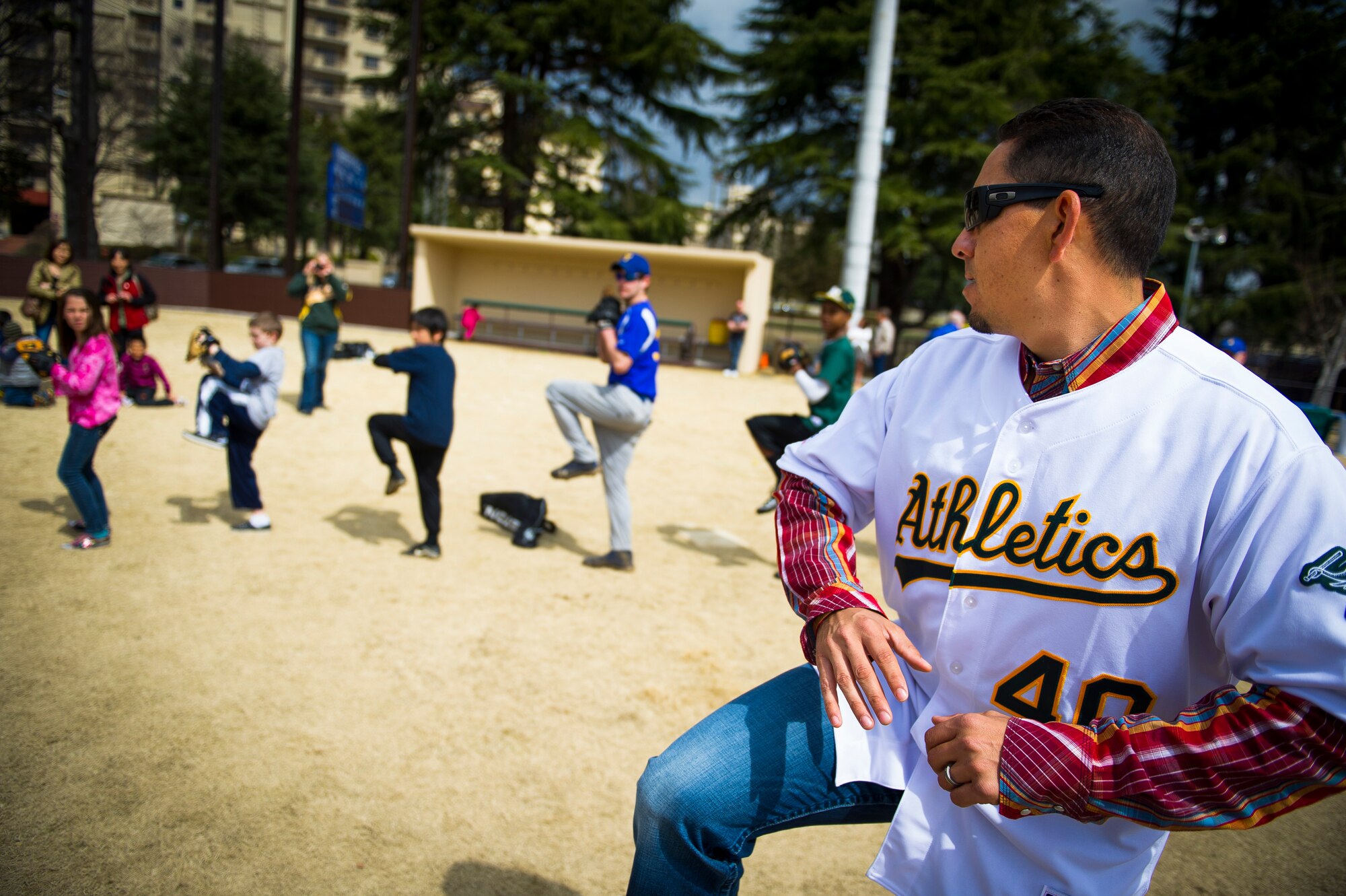YOKOTA AIR BASE, Japan -- Brian Fuentes, Oakland Athletics starting pitcher, demonstrates the proper pitching technique to kids here at Yokota Air Base, Japan, March 25, 2012. Brian Fuentes discussed pitching mechanics and even allowed the children to pitch to him. (U.S. Air Force photo/Staff Sgt. Chad C. Strohmeyer)