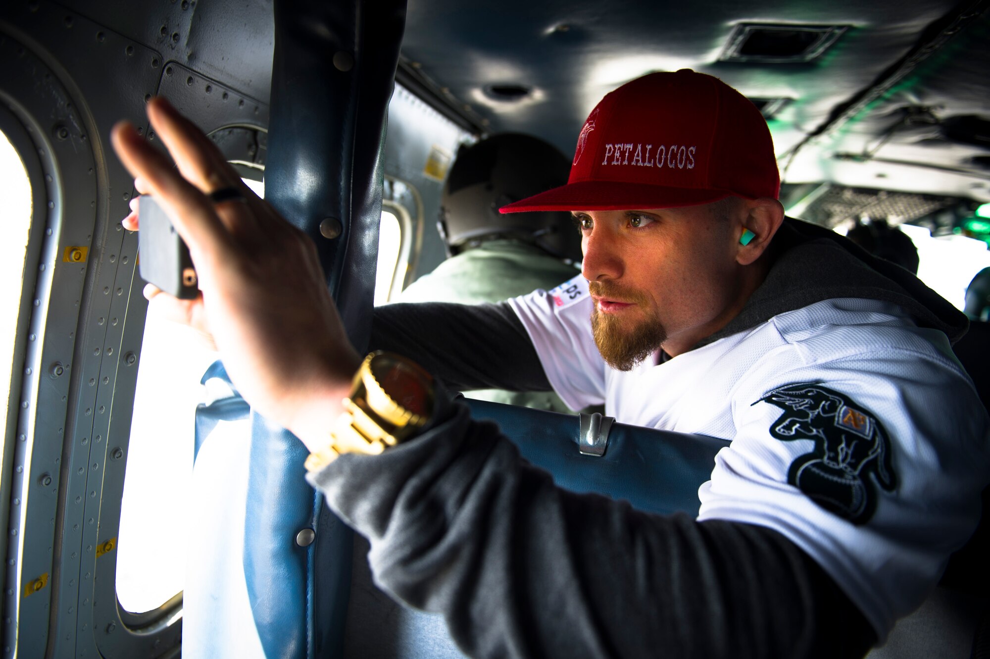 YOKOTA AIR BASE, Japan -- Jonny Gomes, Oakland Athletics left fielder, takes a picture out the window of a UH-1N Iroquois during their flight to Yokota Air Base March 25, 2012. Eight players from the Athletics came to Yokota to meet with kids, eat lunch with Airmen and sign autographs. (U.S. Air Force photo/Staff Sgt. Chad C. Strohmeyer)