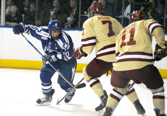 Paul Weisgarber tries to push past two Boston College Eagles during the NCAA Hockey Championship Tournament Saturday, March 24, 2012. The Falcons came up short against the Eagles 2-0. This was the Falcons' fifth trip to the tournament in the last six years. (U.S. Air Force photo/Tech. Sgt. Raymond Hoy)